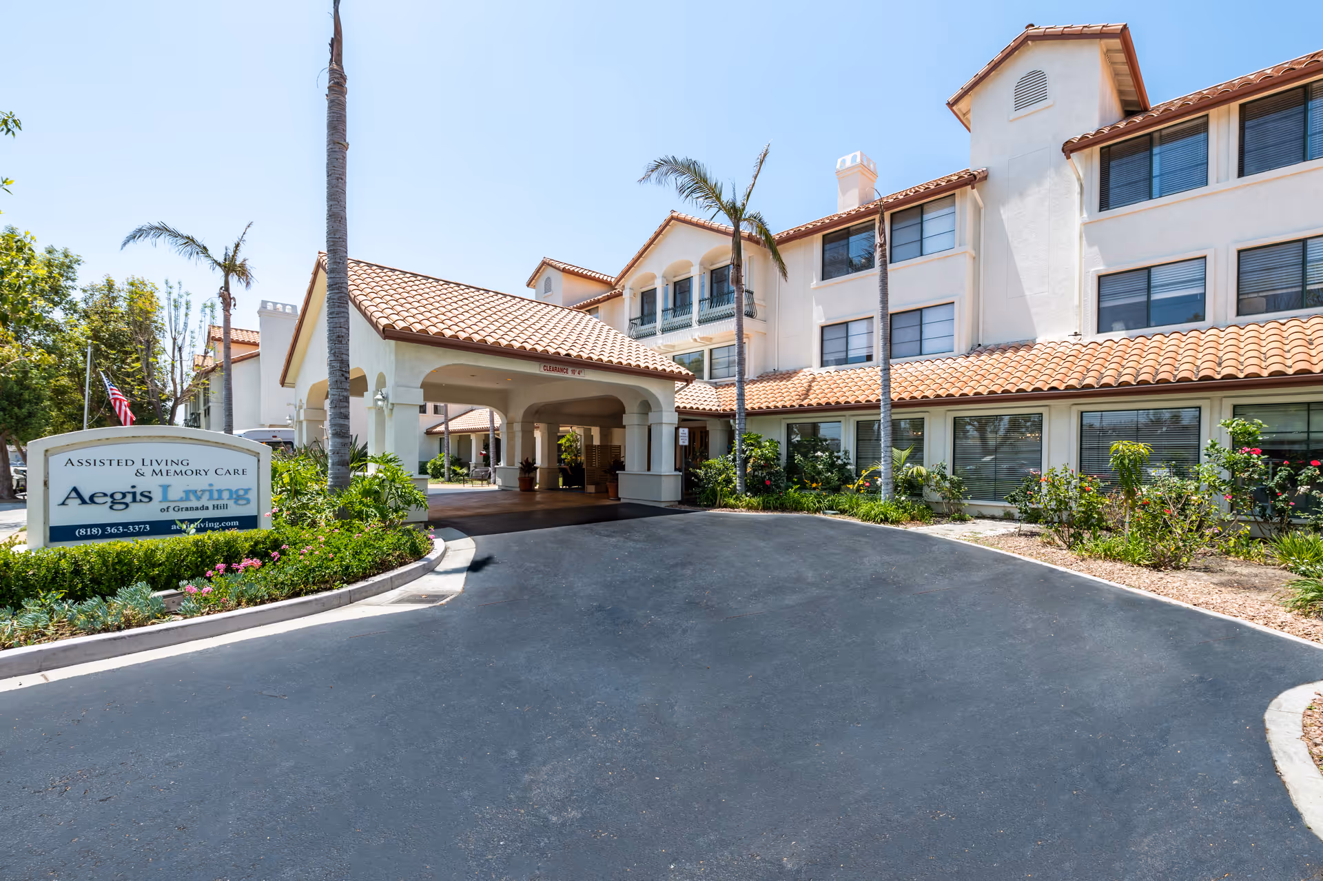 Exterior view of Aegis Living Granada Hills with entrance and landscaping.