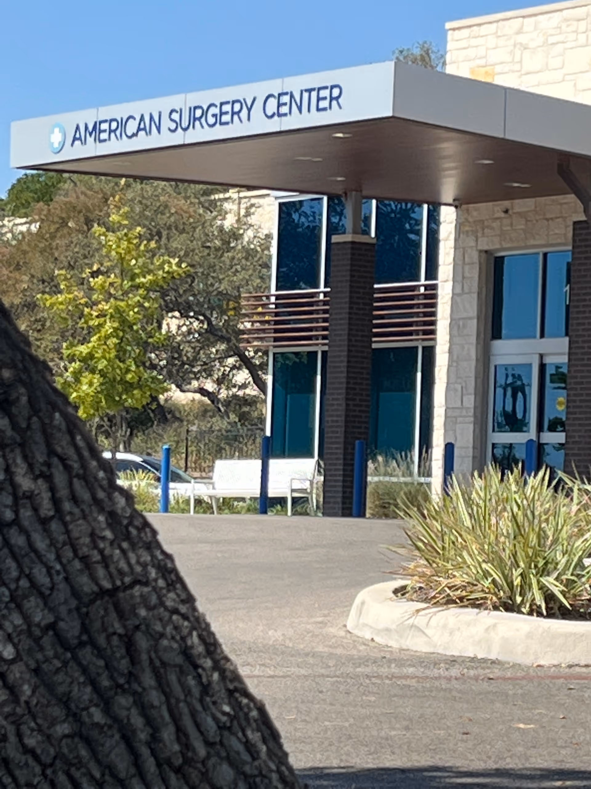 Exterior view of the American Surgery Center entrance with canopy and signage.