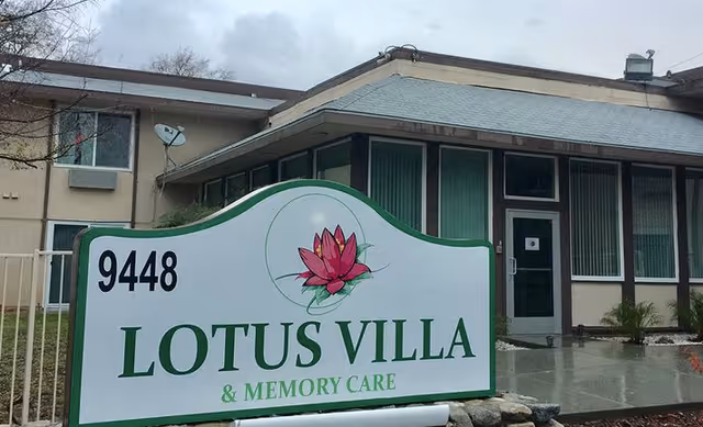 Exterior view of Lotus Villa & Memory Care with a large front sign.
