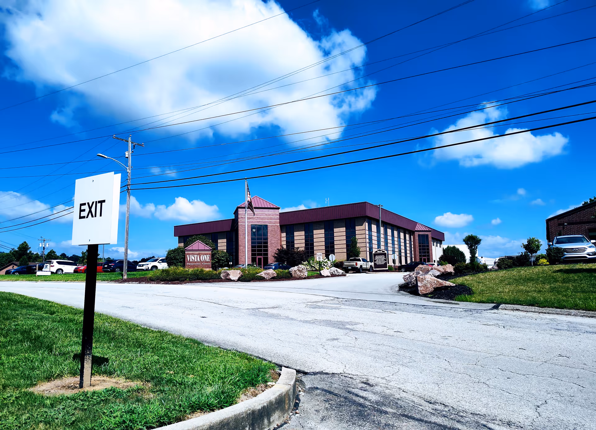 Exterior view of Grane Hospice Care Charleroi building with parking lot and blue sky