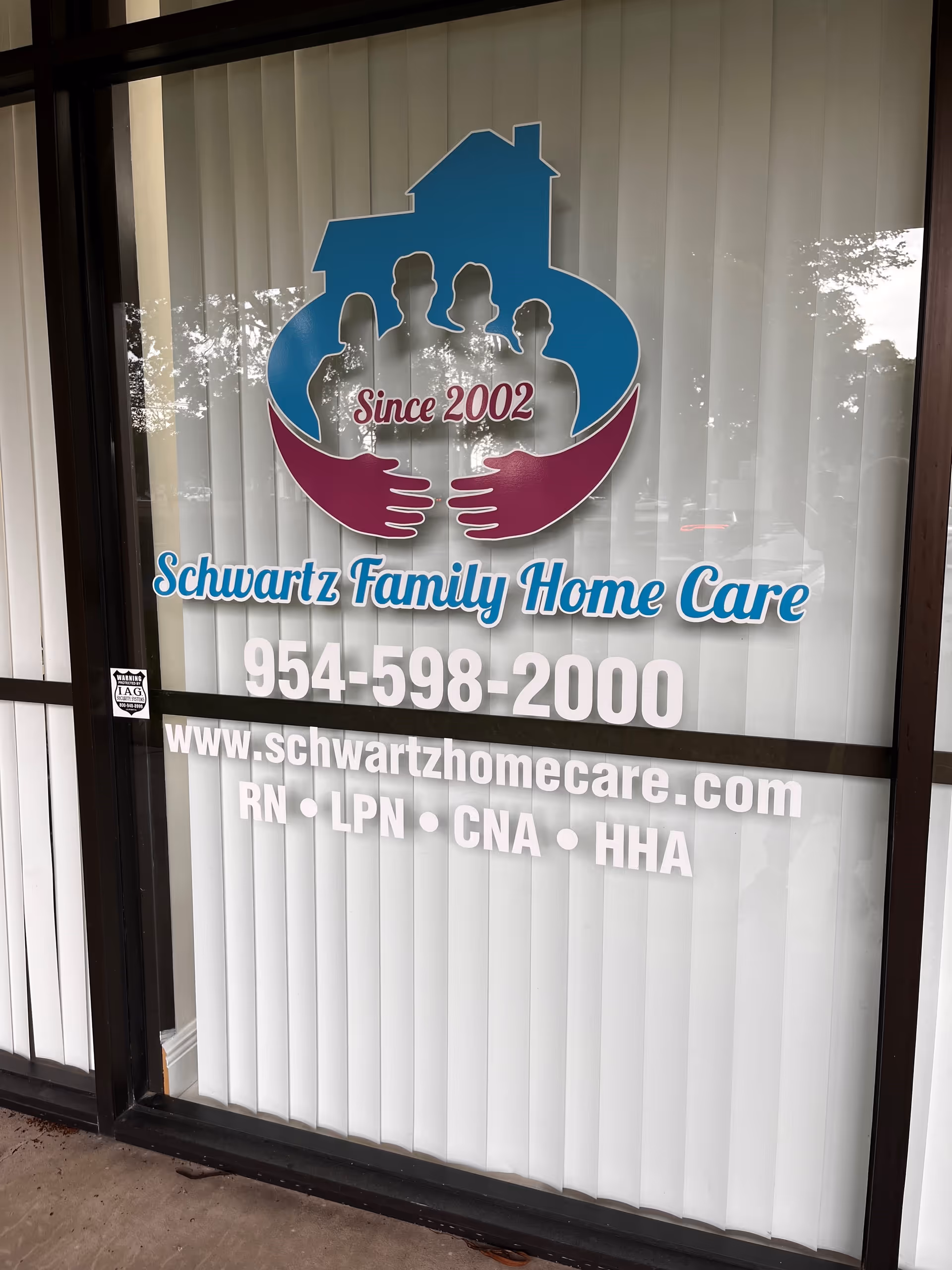 Window sign shows Schwartz Family Home Care logo, contact info, and website on glass.