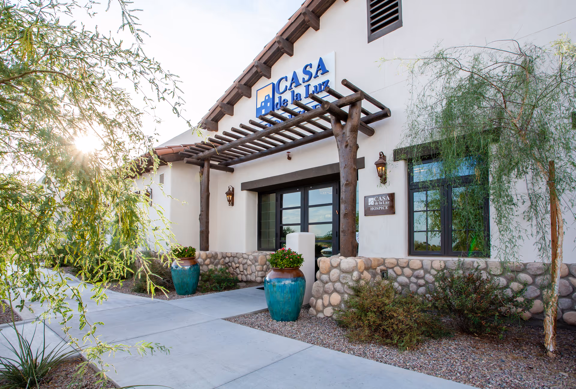 Exterior view of Casa de la Luz Hospice at the Hacienda, entrance with ledge and planters
