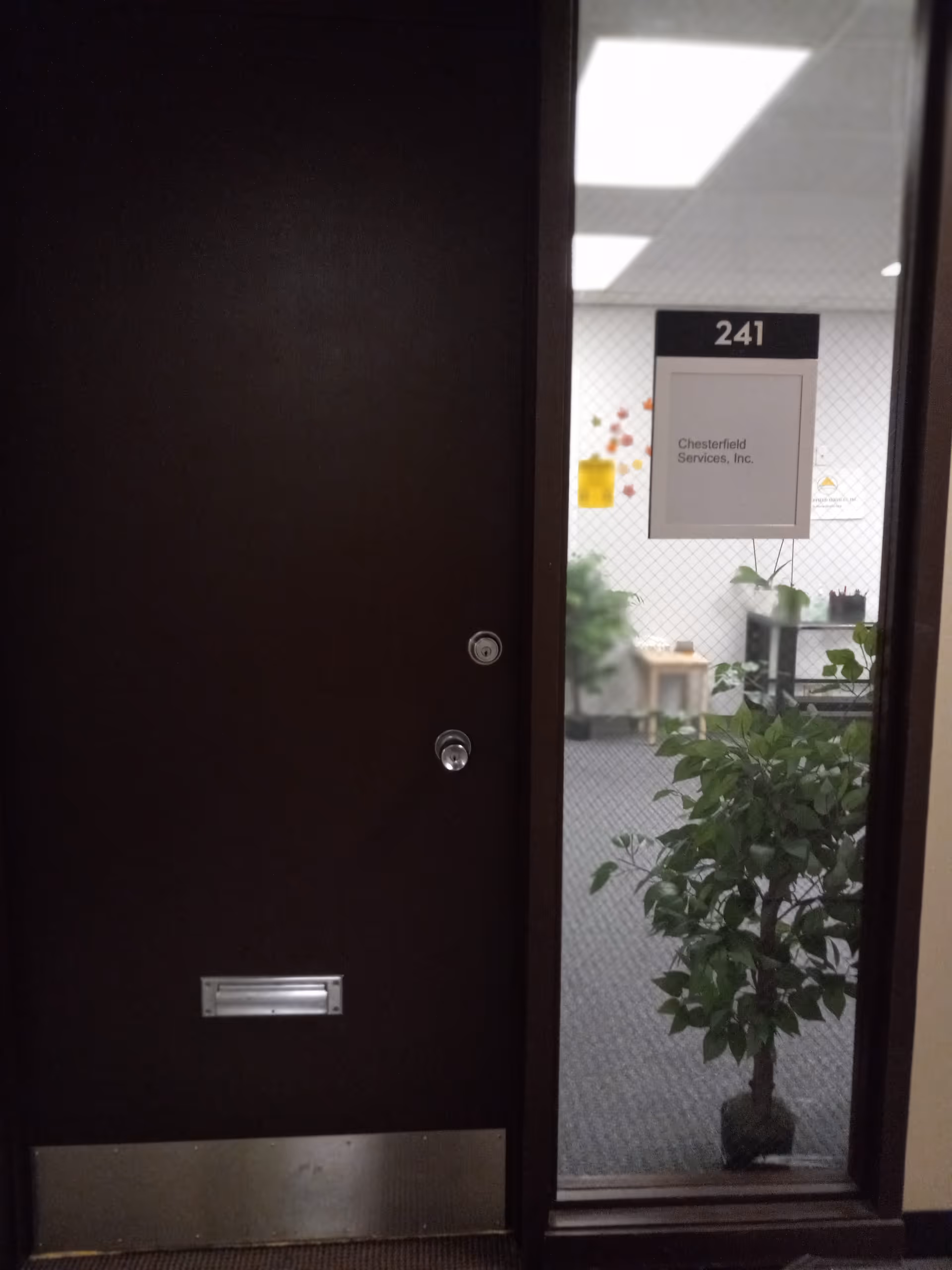 Doorway opens to a room marked 241 with a Chesterfield Services, Inc. sign.