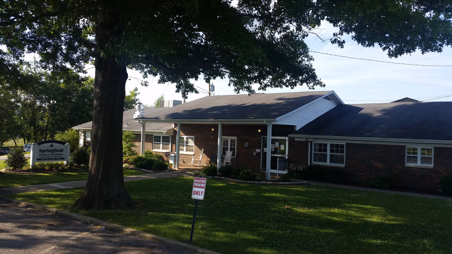 Single-story brick Springfield Nursing and Rehabilitation Center building with front entrance and manicured lawn.