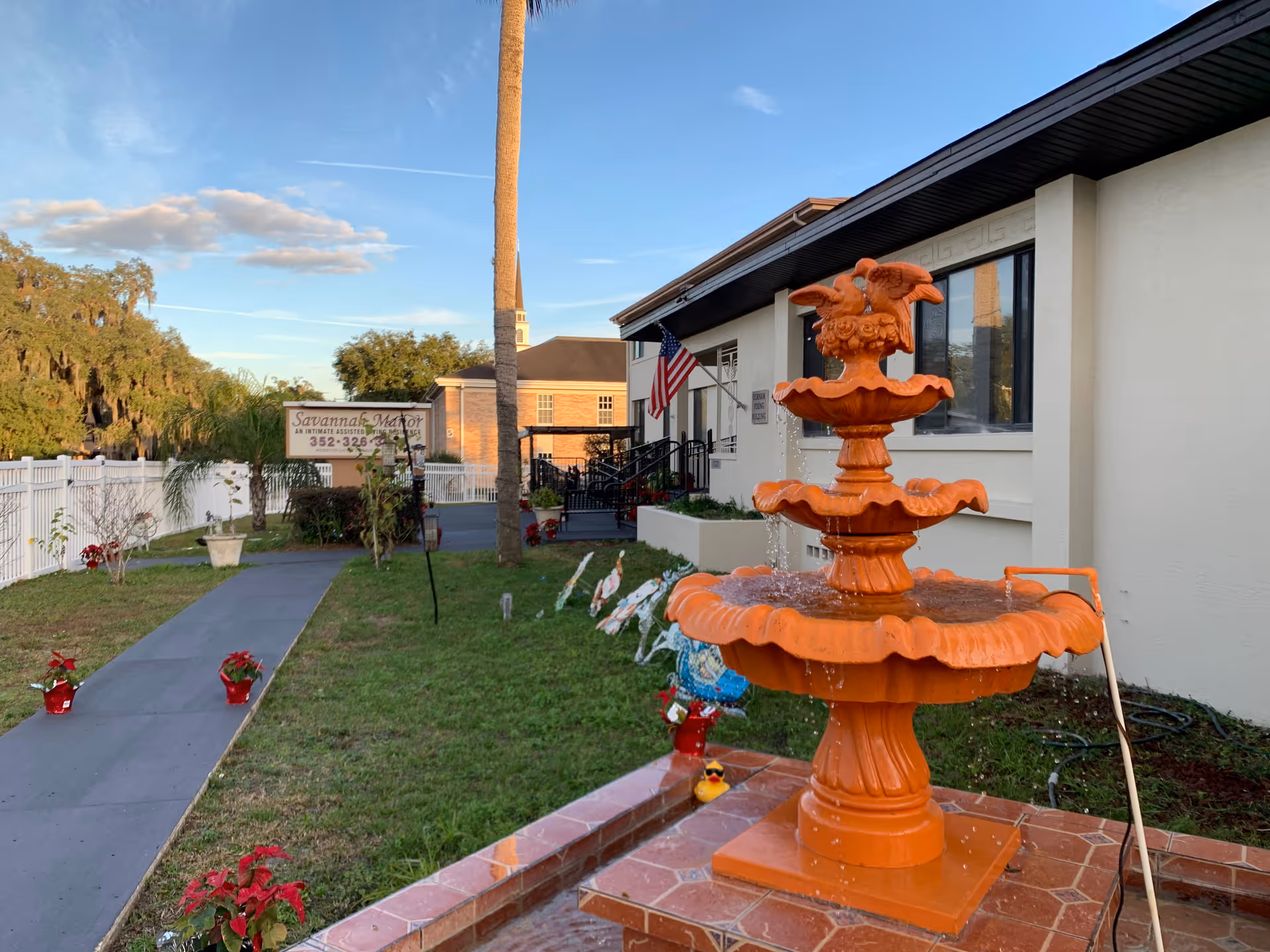 Front exterior of Savannah Court of Leesburg with orange fountain and walkway.