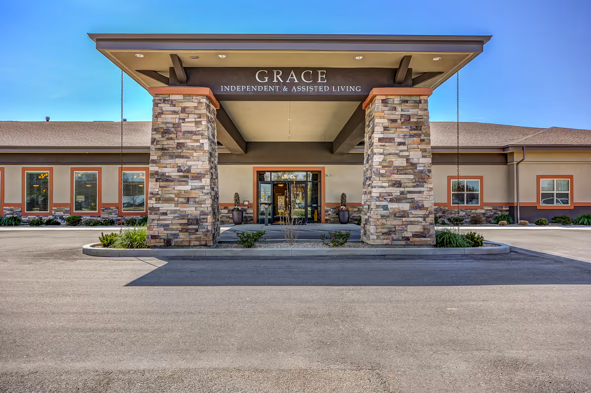 Grace Assisted Living entrance with stone pillars and signage beneath a covered front canopy.