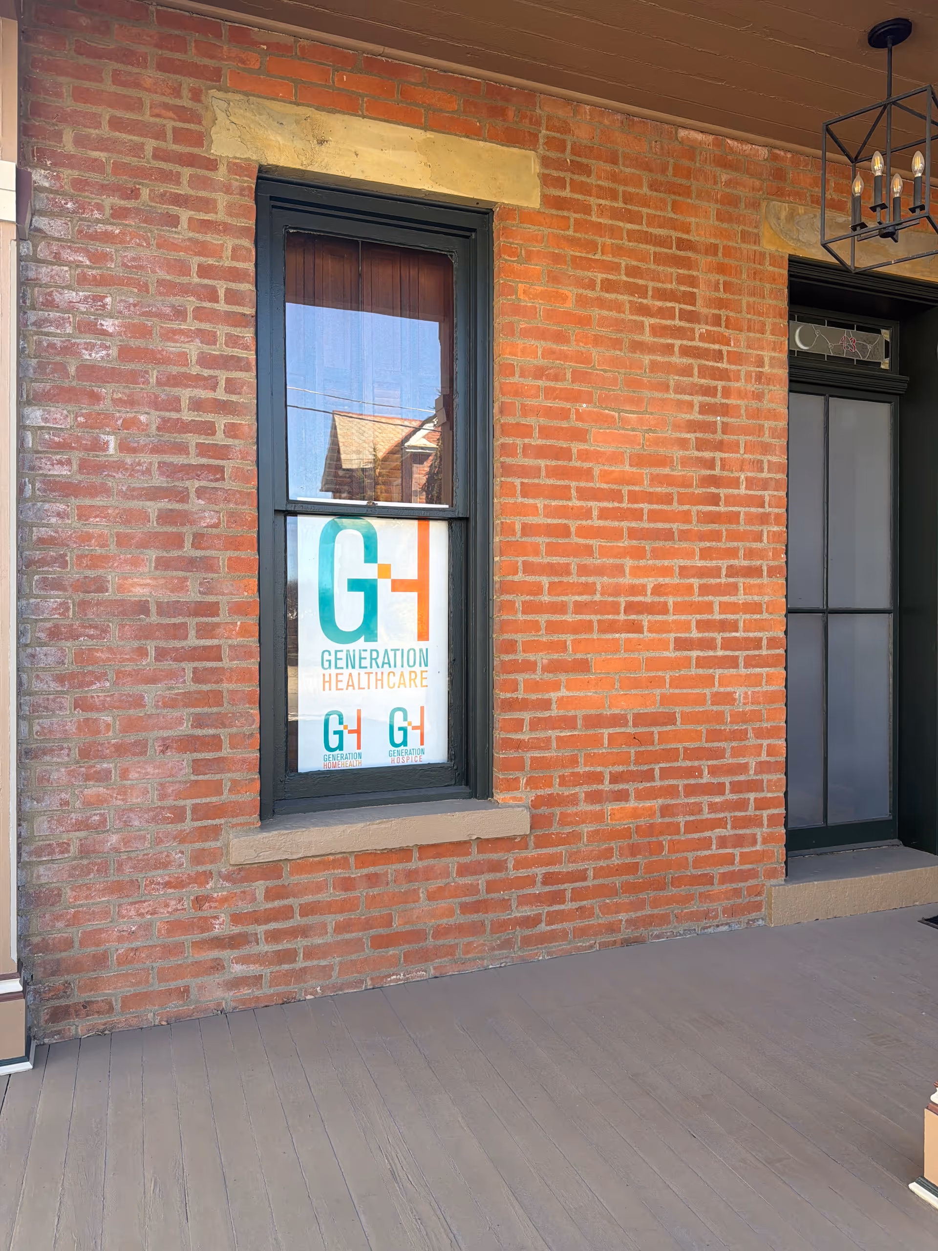 Brick exterior with a window sign reading Generation Healthcare.