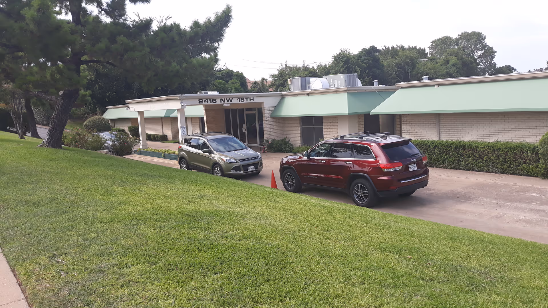 Exterior view of the River Oaks Health and Rehabilitation Center entrance with parked cars