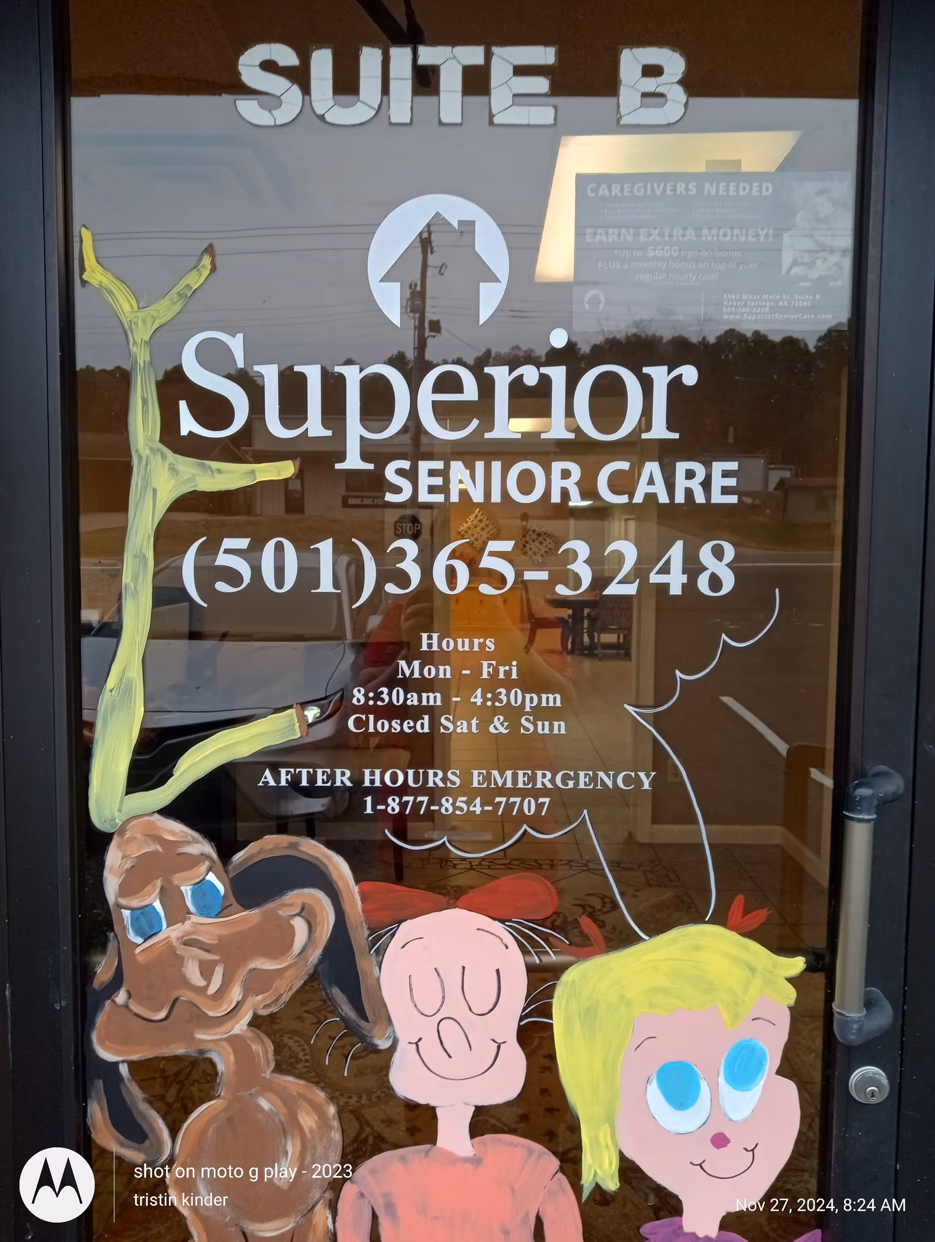 Glass door with Superior Senior Care signage and colorful drawings at entrance.