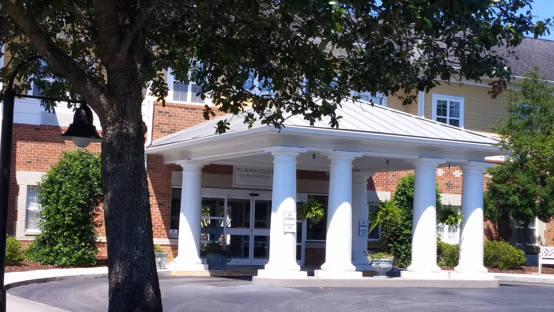 A porticoed entrance with white columns at Morningside of Wilmington.