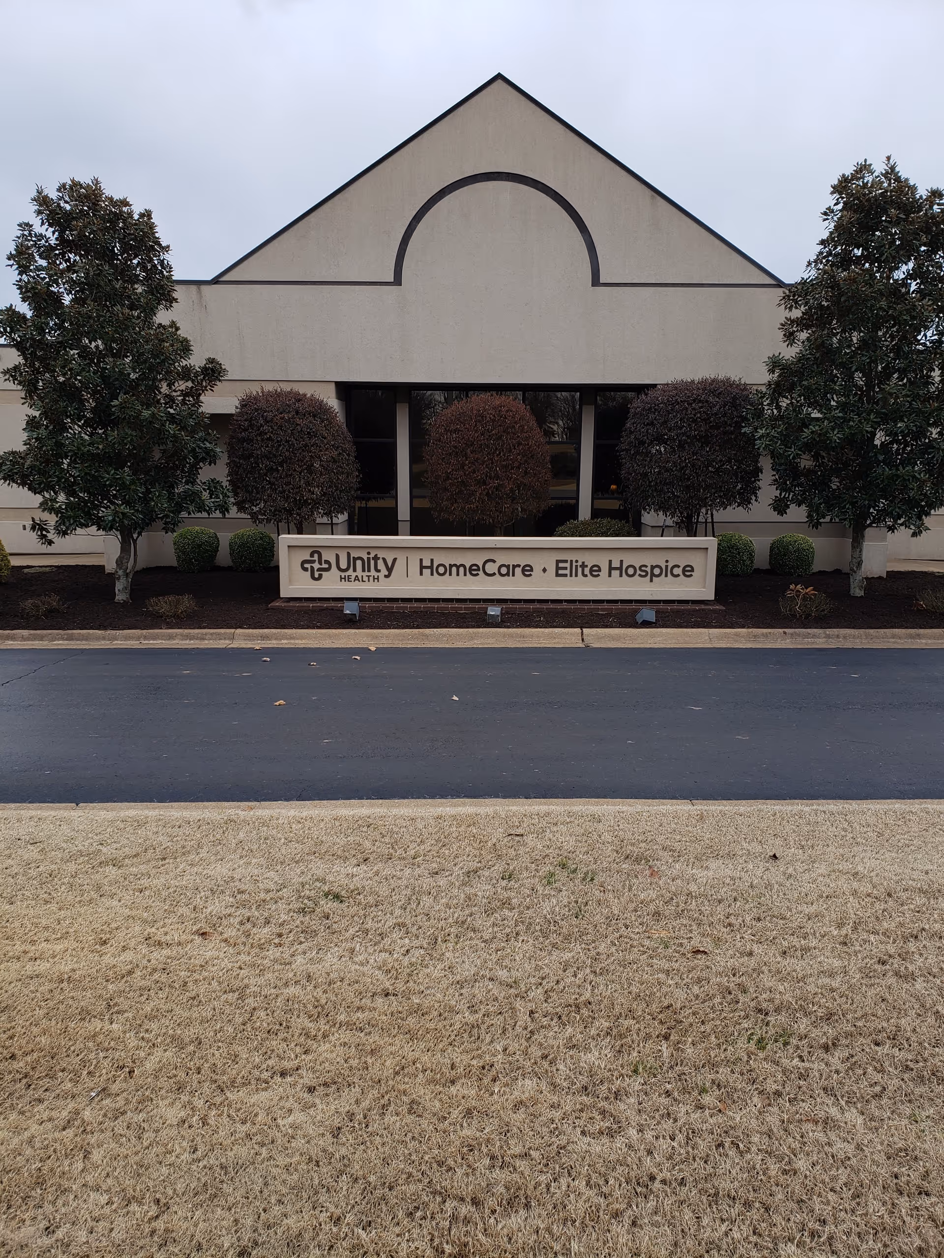 Exterior view of Unity Health HomeCare building with a sign and shrubs.
