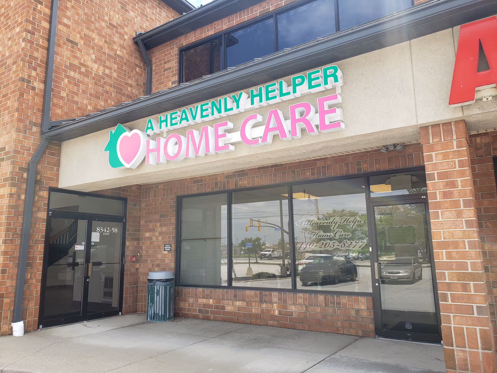 Exterior view of a brick storefront showing A Heavenly Helper Home Care sign.
