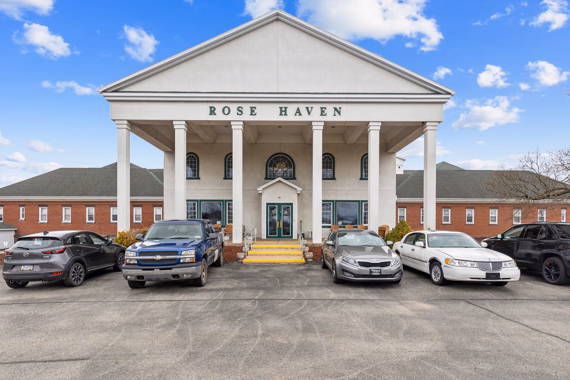 Front view of Rose Haven Personal Care Home with cars in parking lot