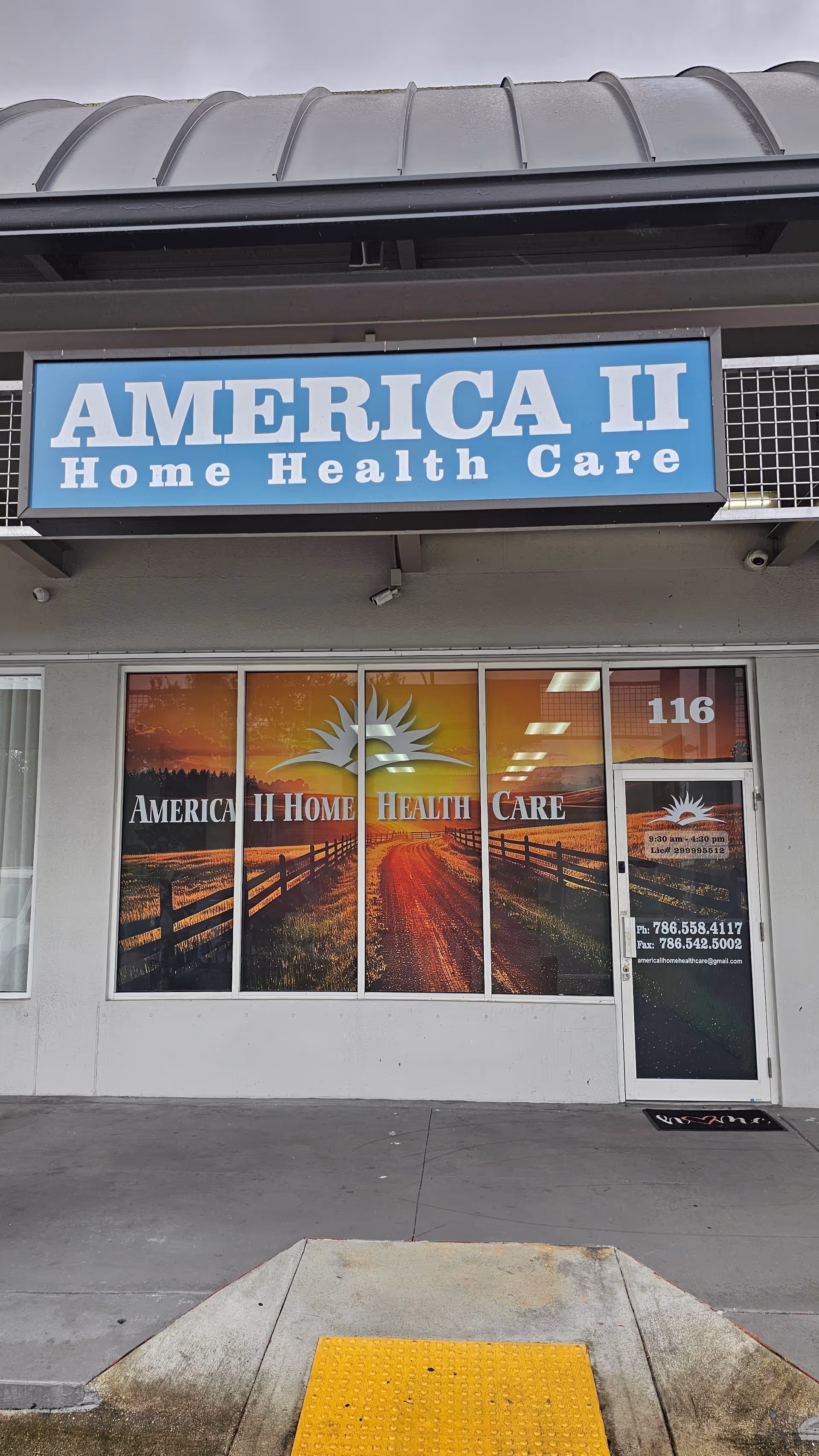 Storefront of America II Home Health Care with blue sign and large windows.