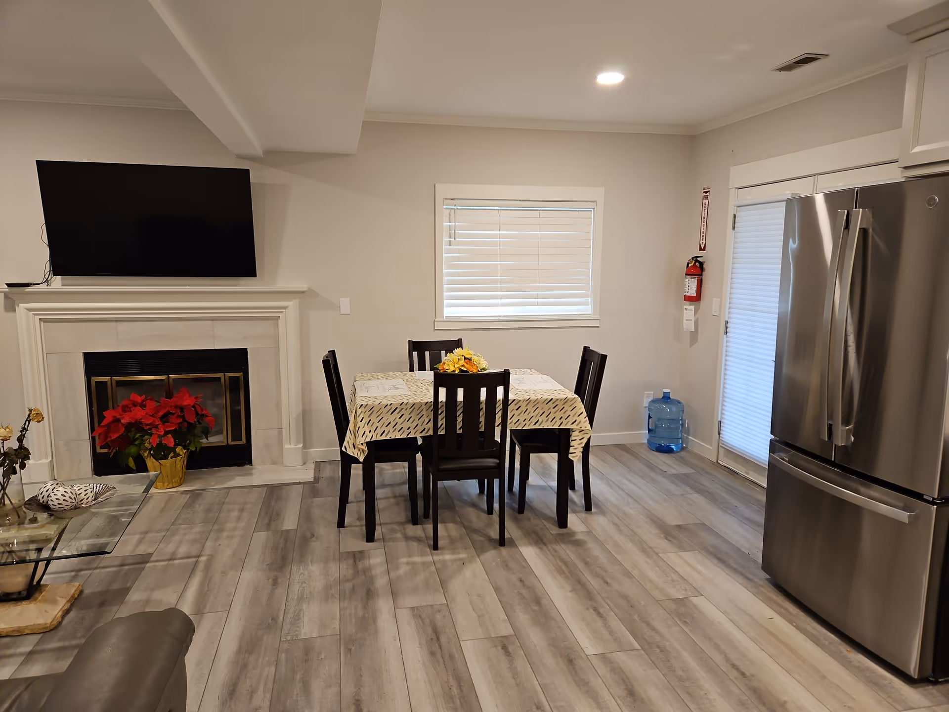 Dining table with six chairs in a bright kitchen-dining area.