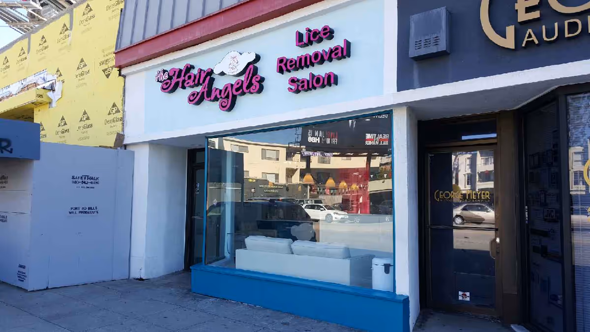 Front of a retail salon named The Hair Angels with a large window display.