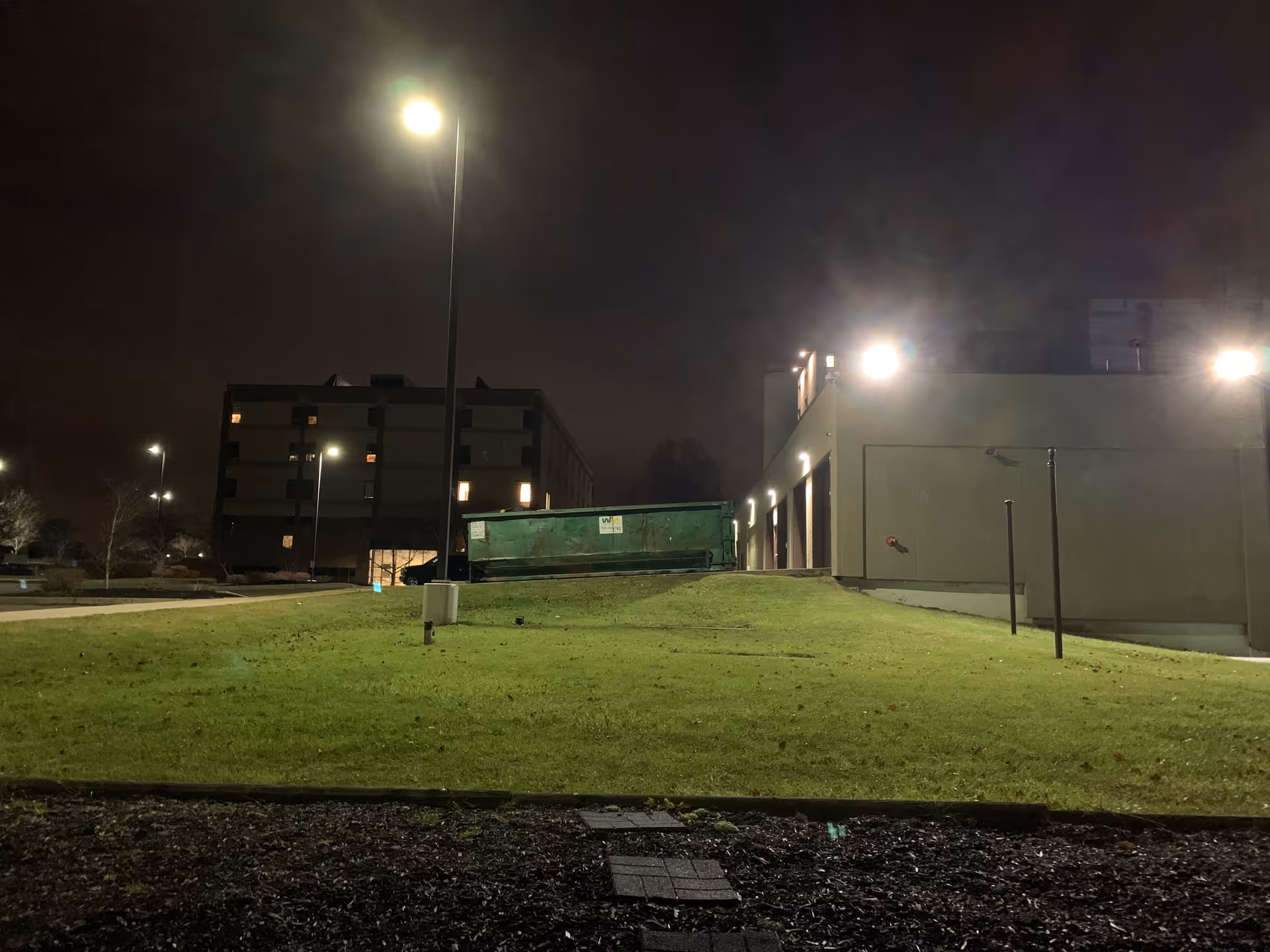 Night exterior of Weirton Medical Center Main Hospital with grass and bright lighting