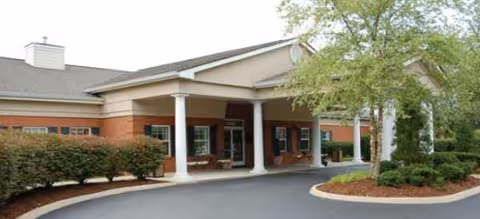 Exterior view of Brookdale Johnson City front entrance with columns and landscaping.