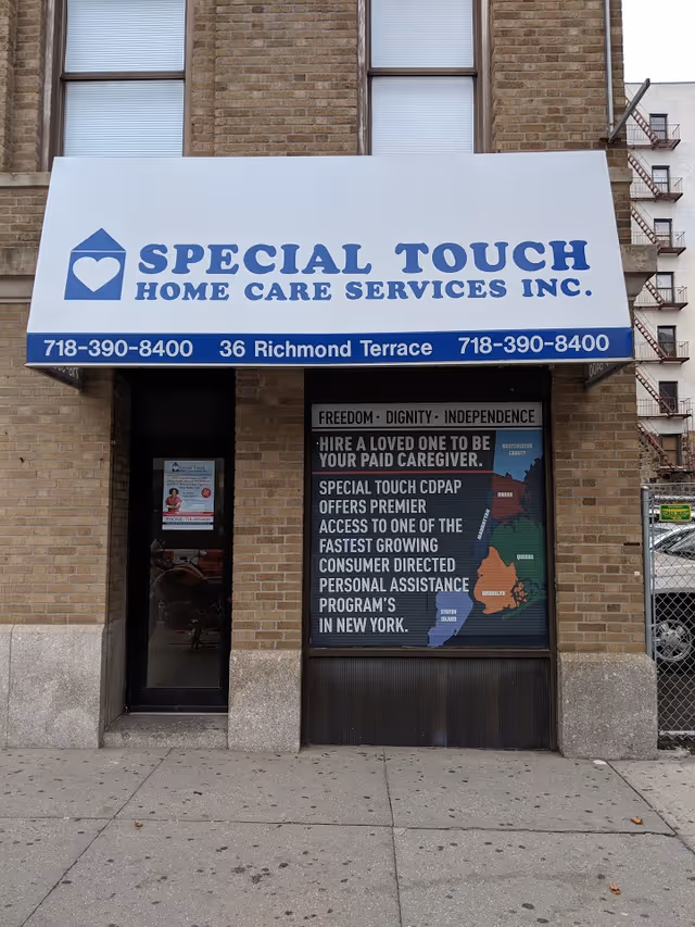 Brick building with a large blue-and-white sign for Special Touch Home Care Services.