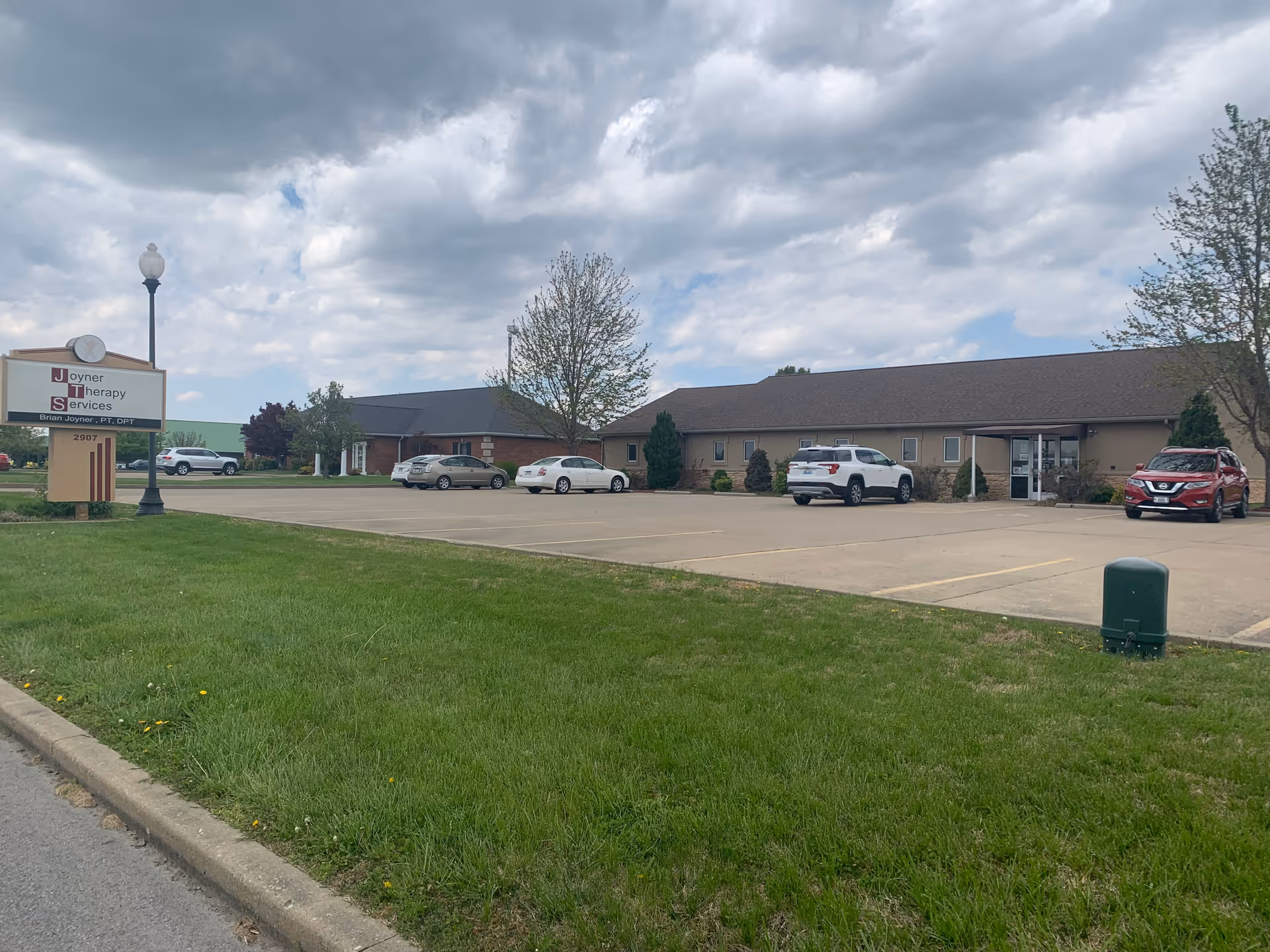 Exterior view of Joyner Therapy Services building with parking lot and sign.
