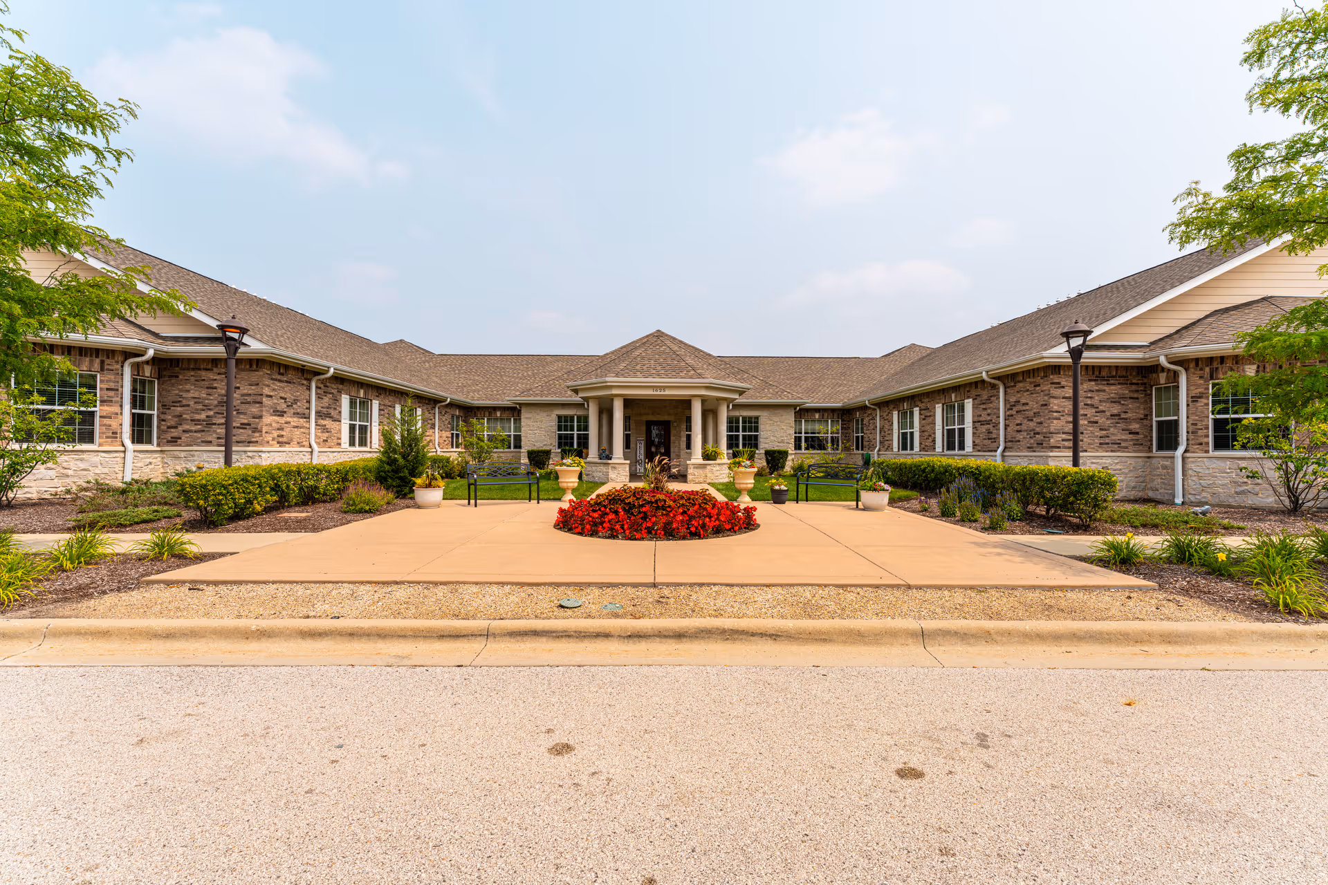 Exterior view of Volante Senior Living of Arlington Heights with central entrance and landscaped courtyard.