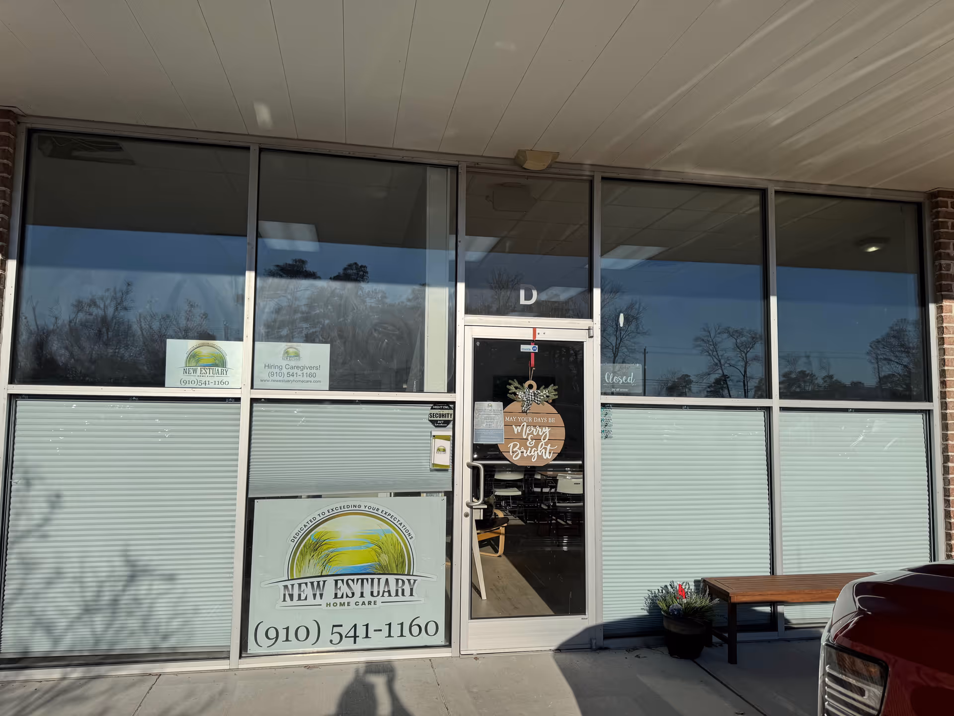 Front entrance of New Estuary Home Care with glass doors and signage