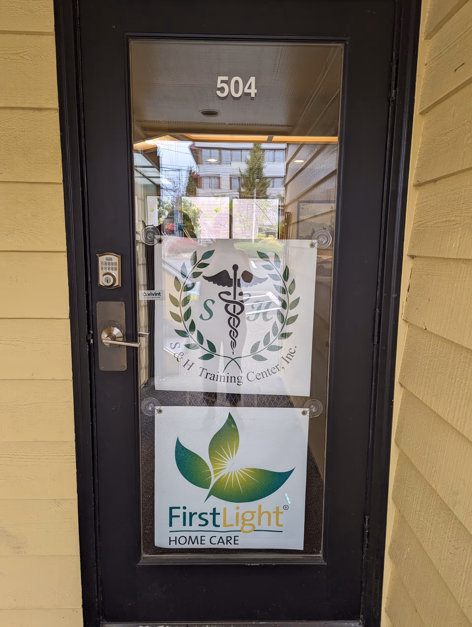 Front door entrance with FirstLight Home Care signage and unit number 504.