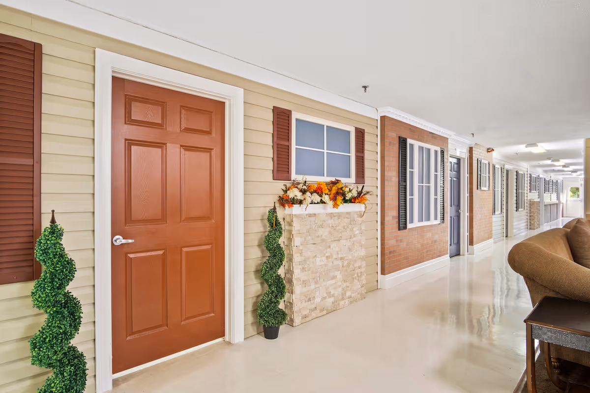 Interior hallway of Cedar Falls Health Care Center with several doors and decor.