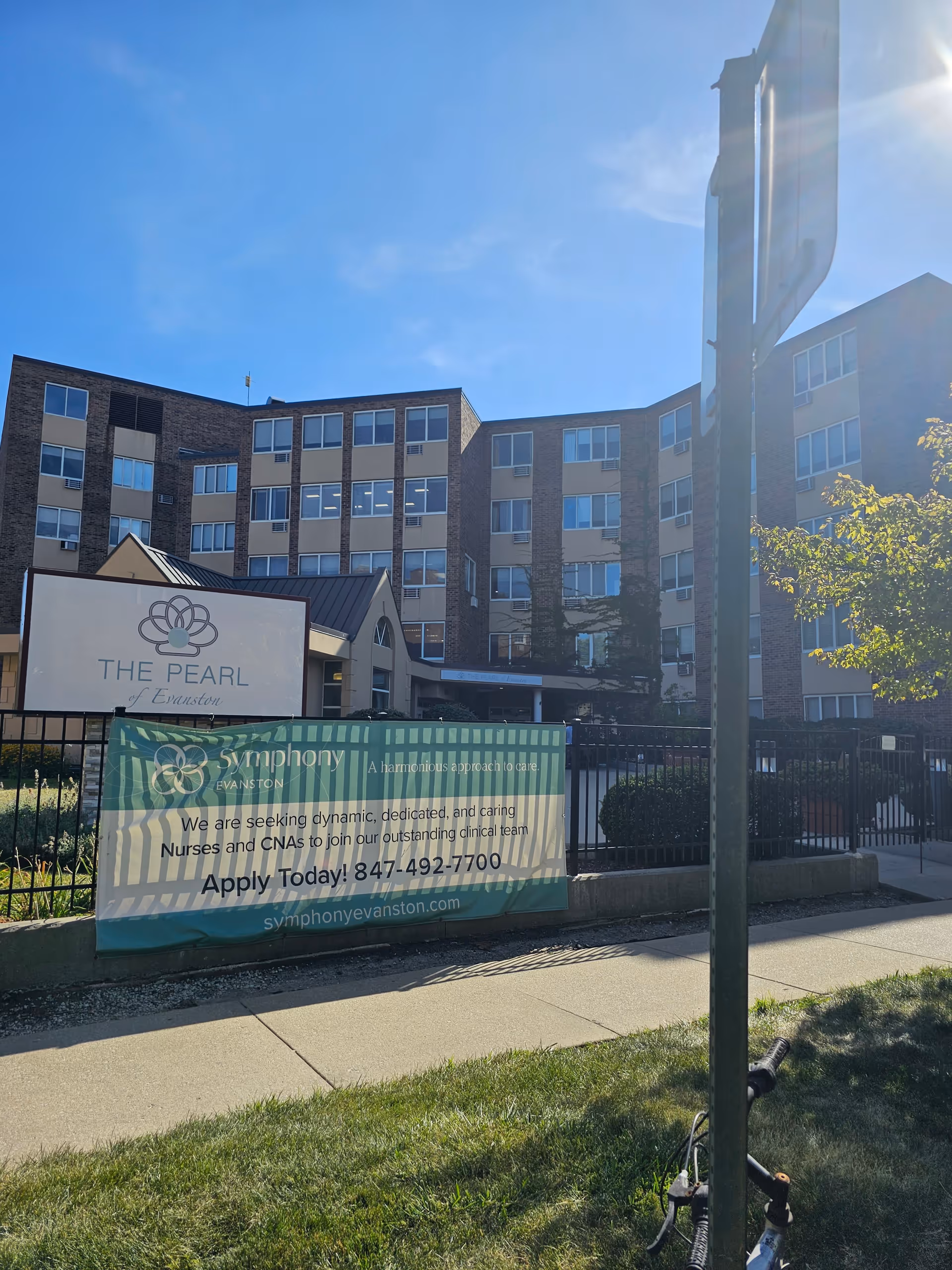 Exterior view of The Pearl of Evanston building with banners advertising job openings.
