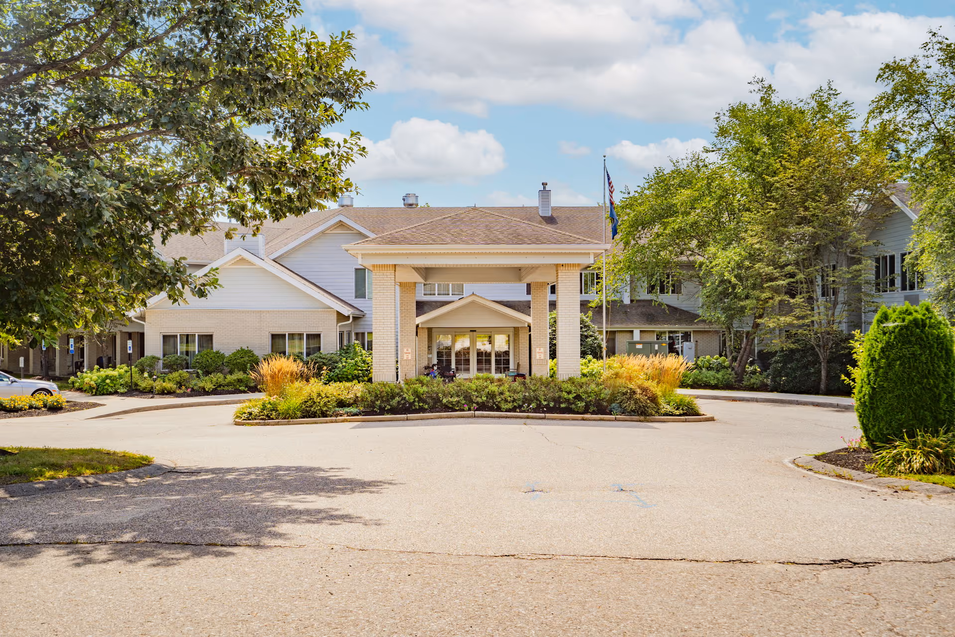 Exterior view of Birchwoods at Canco Senior Living with entrance and landscaping.