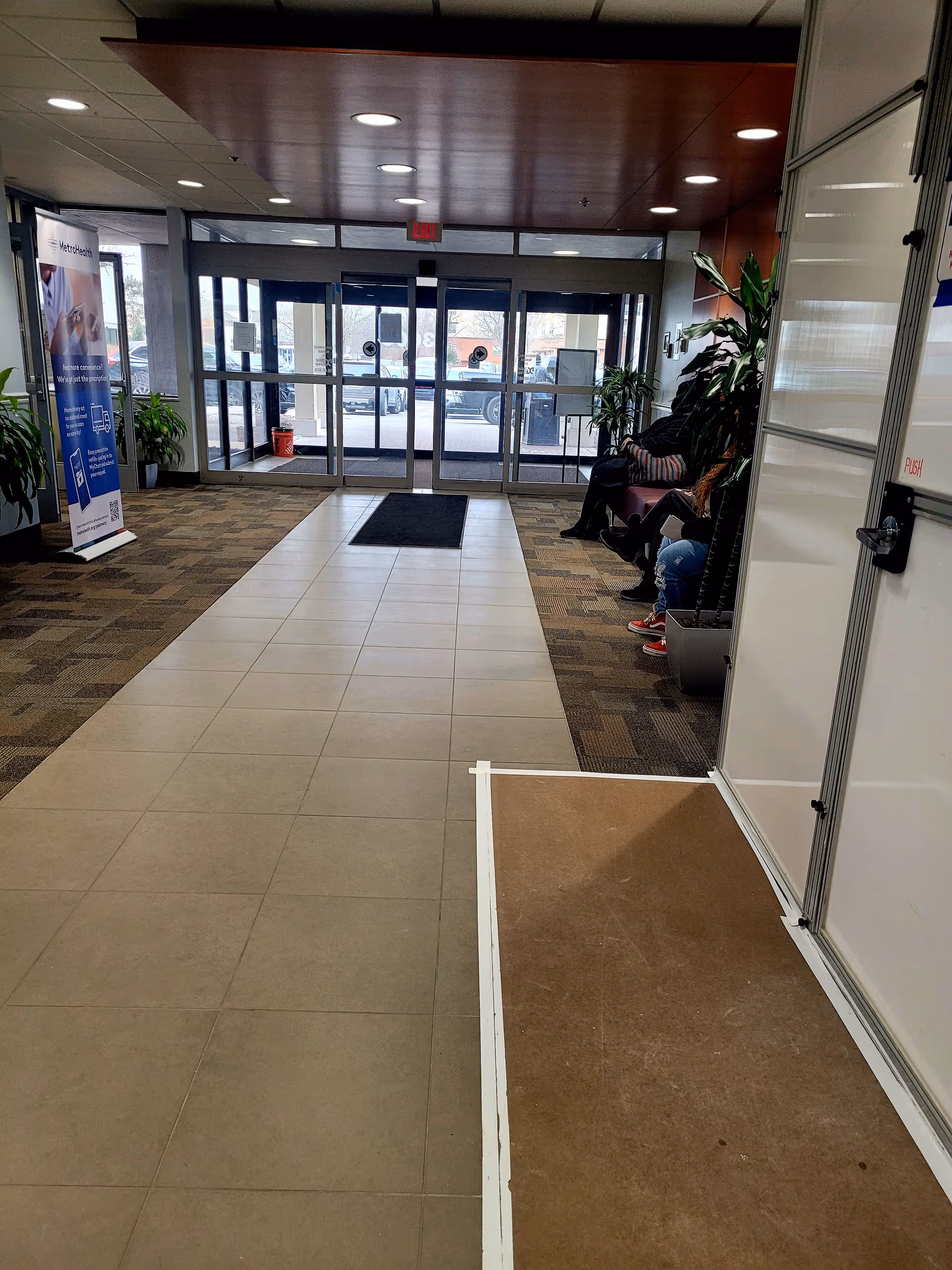 Interior lobby of MetroHealth Beachwood Health Center with glass doors, waiting seating, and plants.