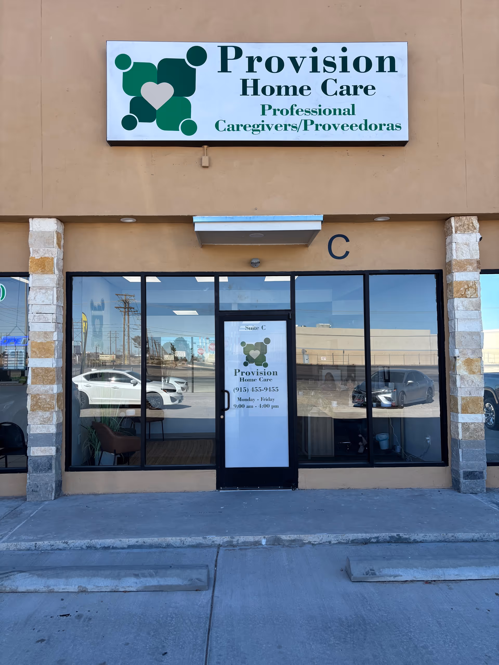 Exterior view of a beige building storefront with a Provision Home Care sign above glass doors.