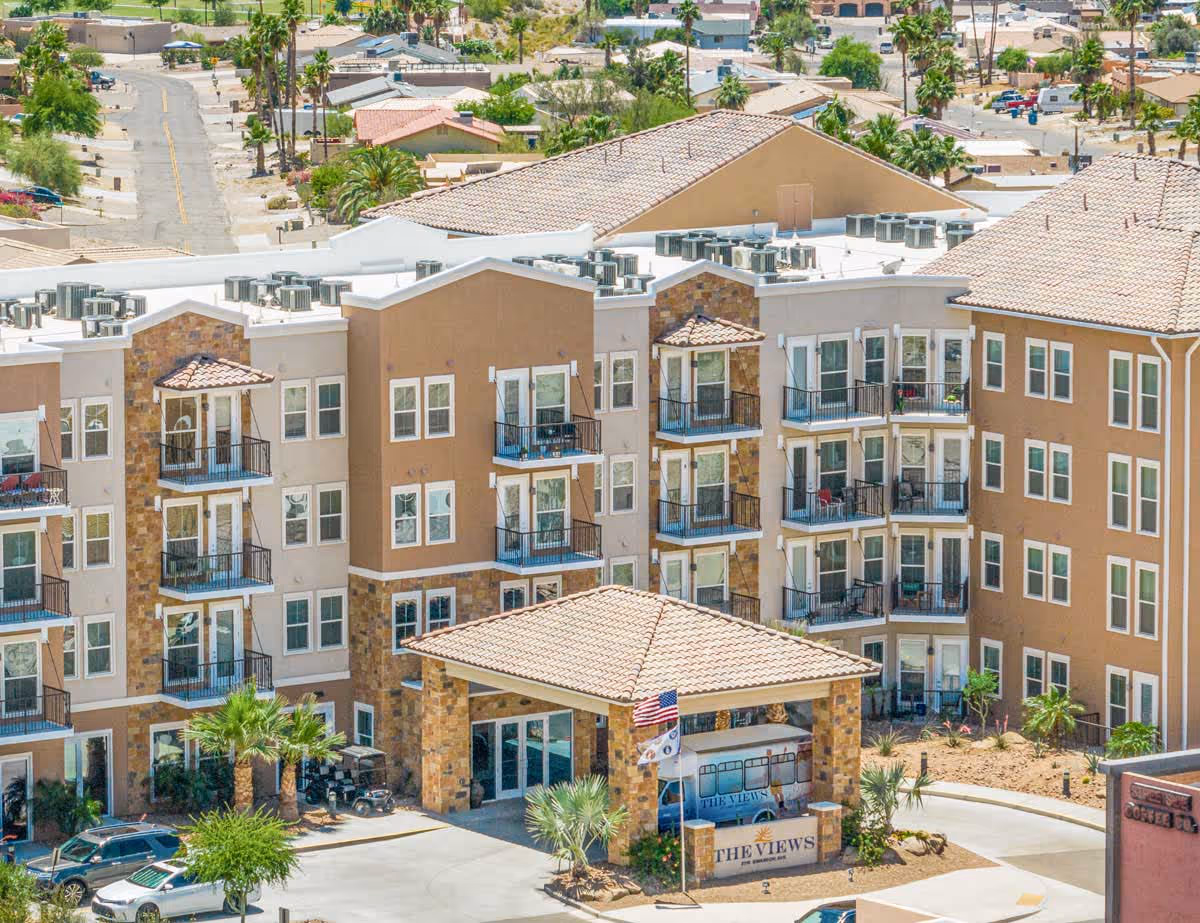 Exterior view of The Views at Lake Havasu senior living building with balconies.