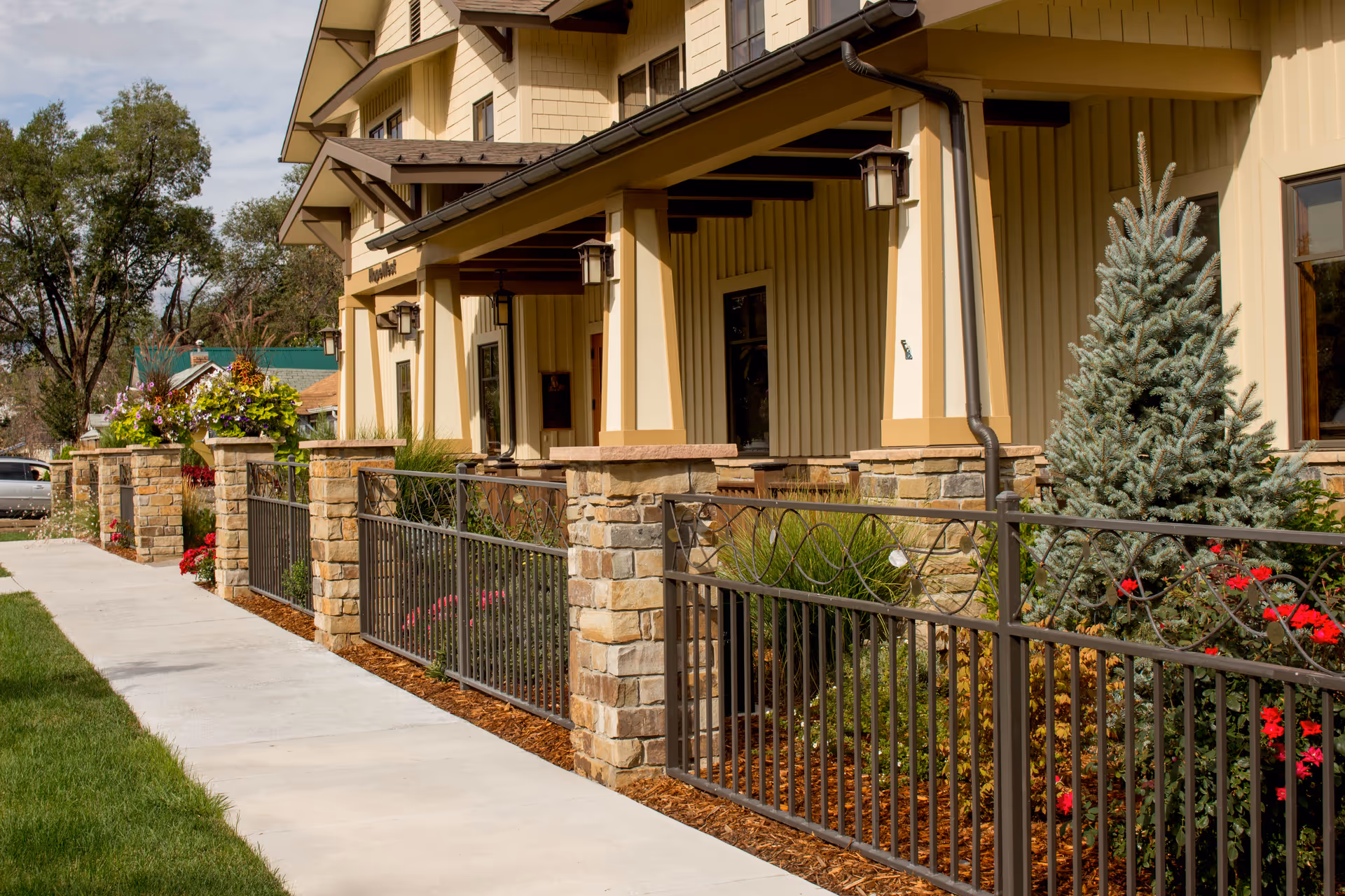 Exterior view of HopeWest Administrative Offices with stone fence and landscaped front.