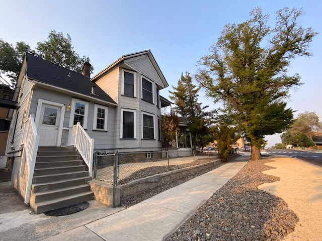 Exterior view of The Willows at Whitaker Park, a two-story senior living building with stairs.