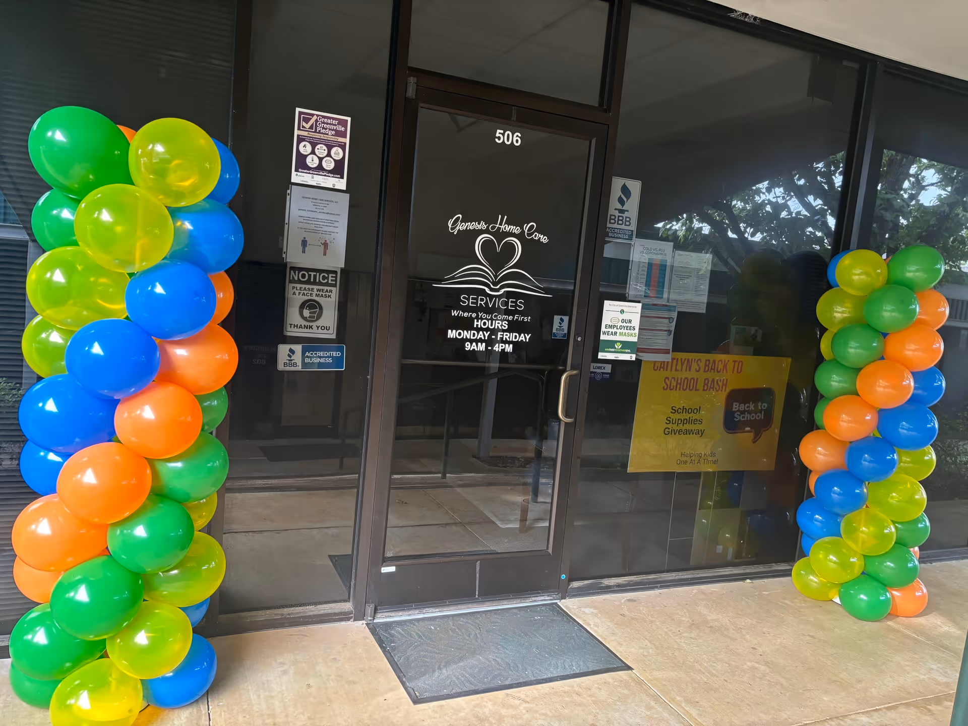 Front entrance of Genesis Home Care Services, LLC with colorful balloon columns on both sides.