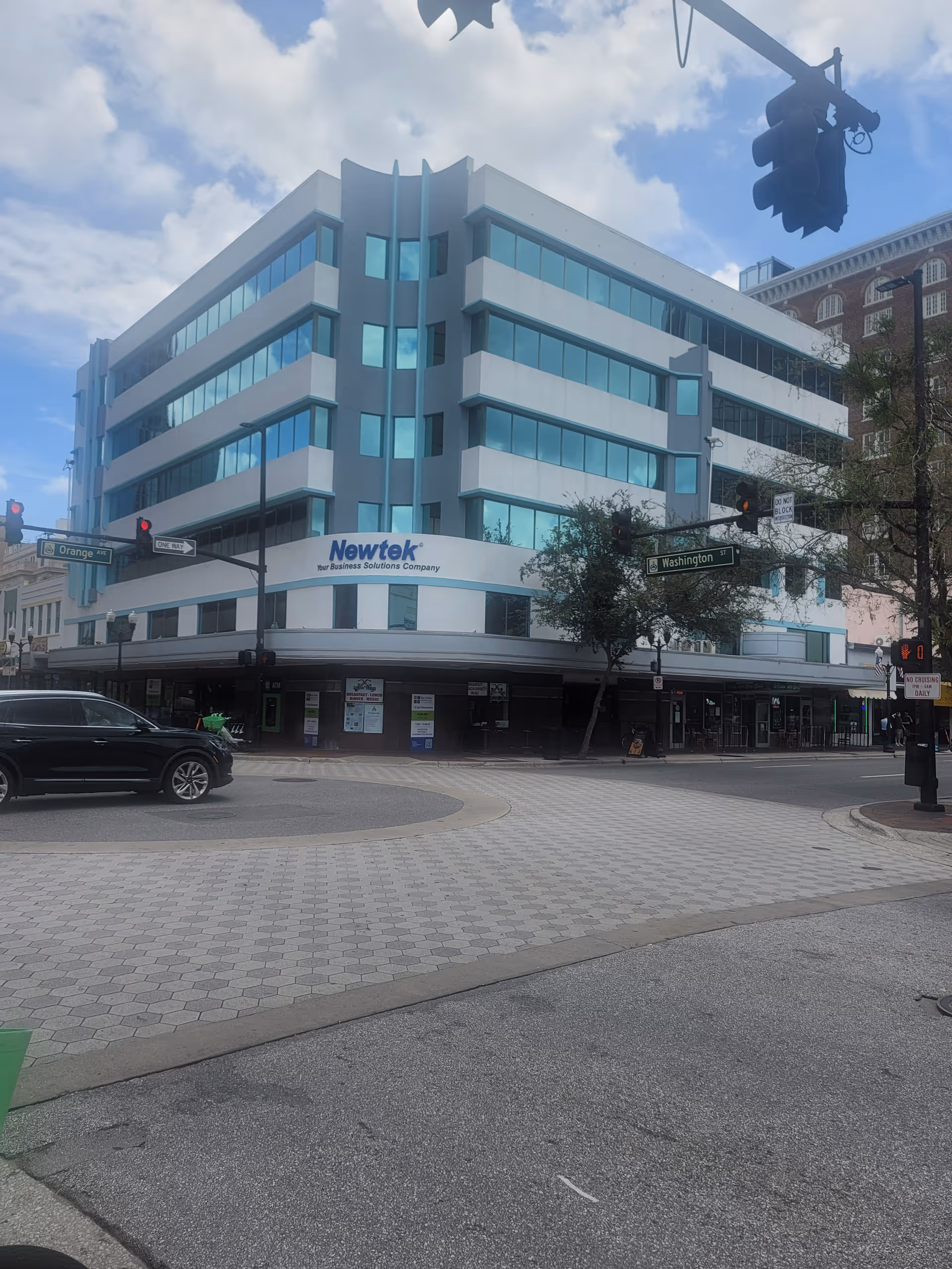 Modern multi-story building at a city street corner.