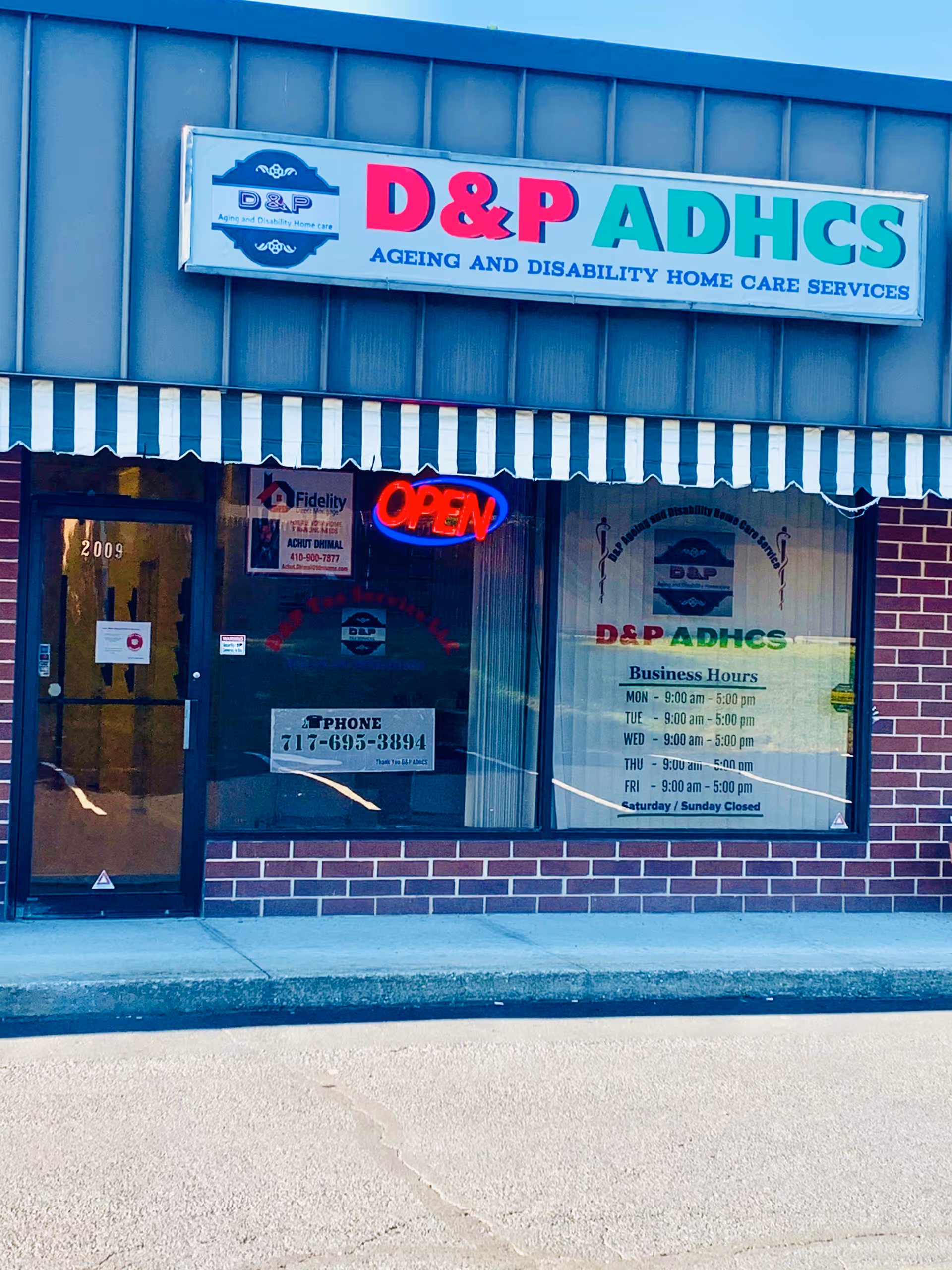 Exterior storefront for DP Home Care Services with D&P ADHCS sign and OPEN neon sign.