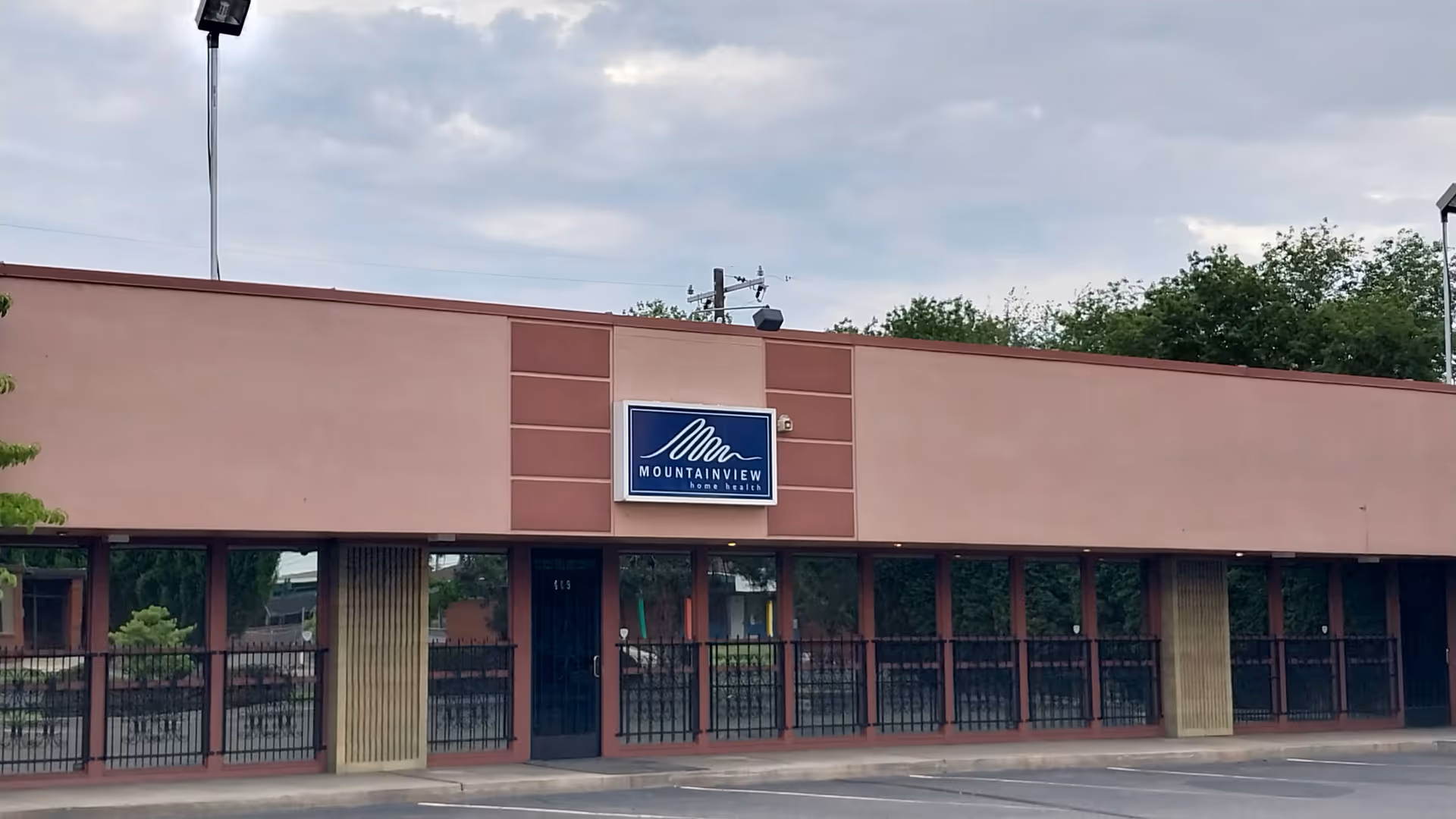 Pink flat-front building with a blue Mountainview Home Health sign.