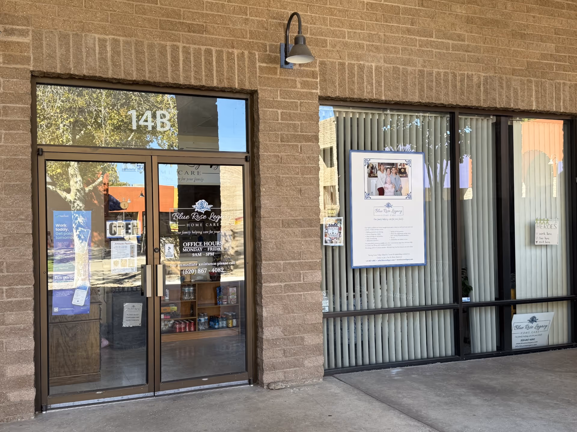 Brick building exterior with glass door entrance and windows displaying Blue Rose Legacy Home Care.
