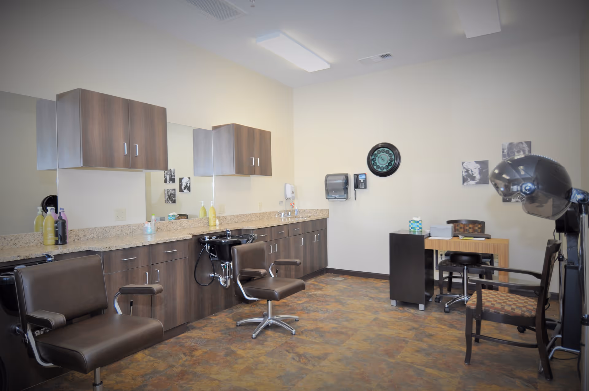 Interior salon area with chairs, sinks, and cabinetry at Pavilion at Glacier Valley
