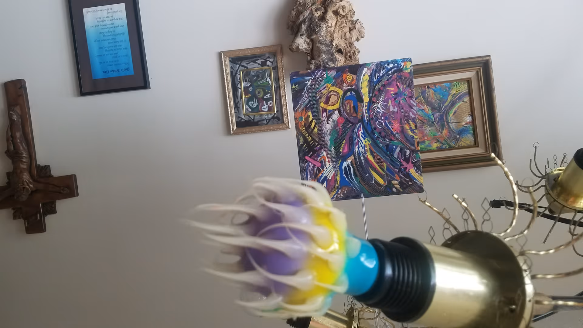 Interior wall featuring assorted framed art and a decorative chandelier.