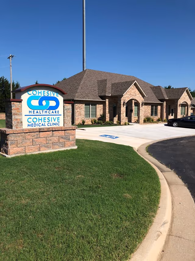 Brick senior care facility exterior with a large Cohesive Healthcare sign.