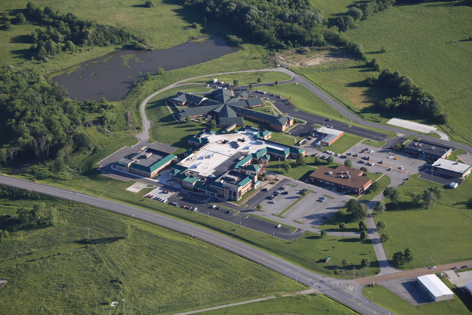 Aerial view of The Living Center campus with multiple buildings, parking lots, and green fields.
