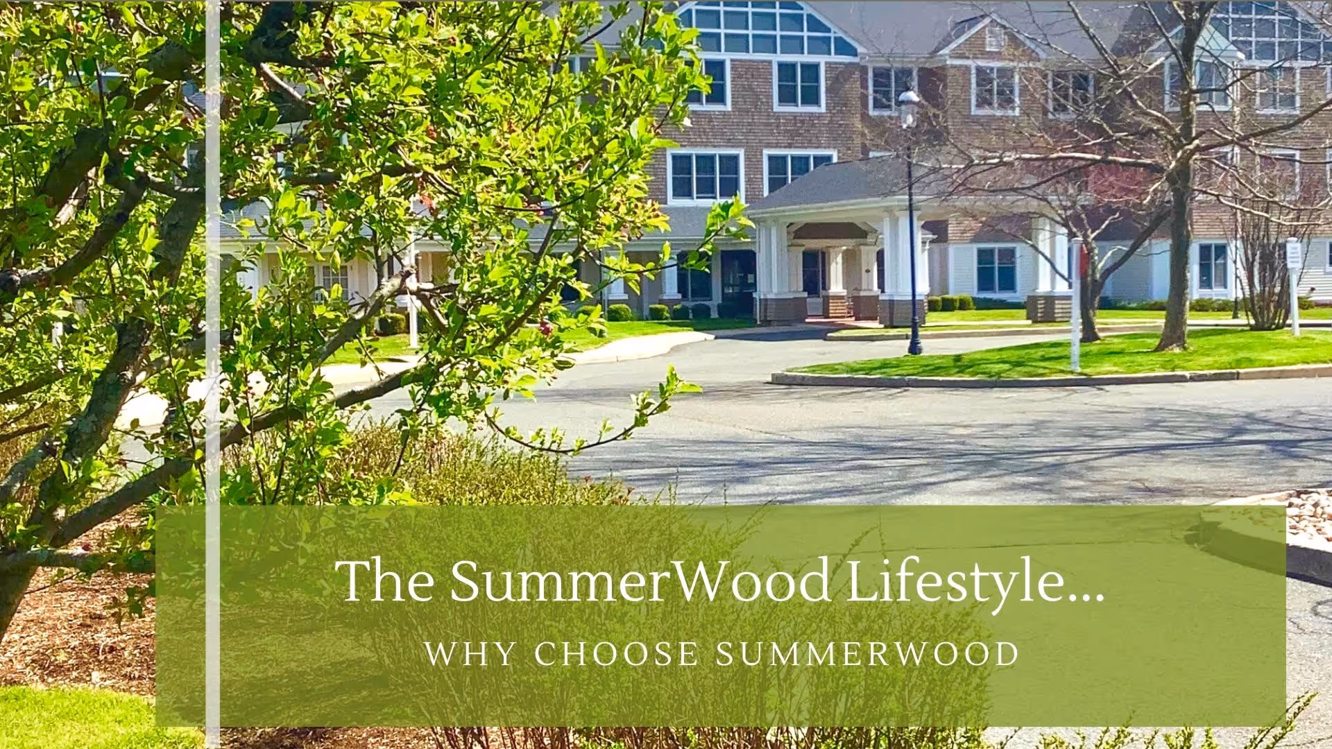 Front entrance of a senior living facility with a driveway, trees, and a green overlay reading "The SummerWood Lifestyle... WHY CHOOSE SUMMERWOOD."