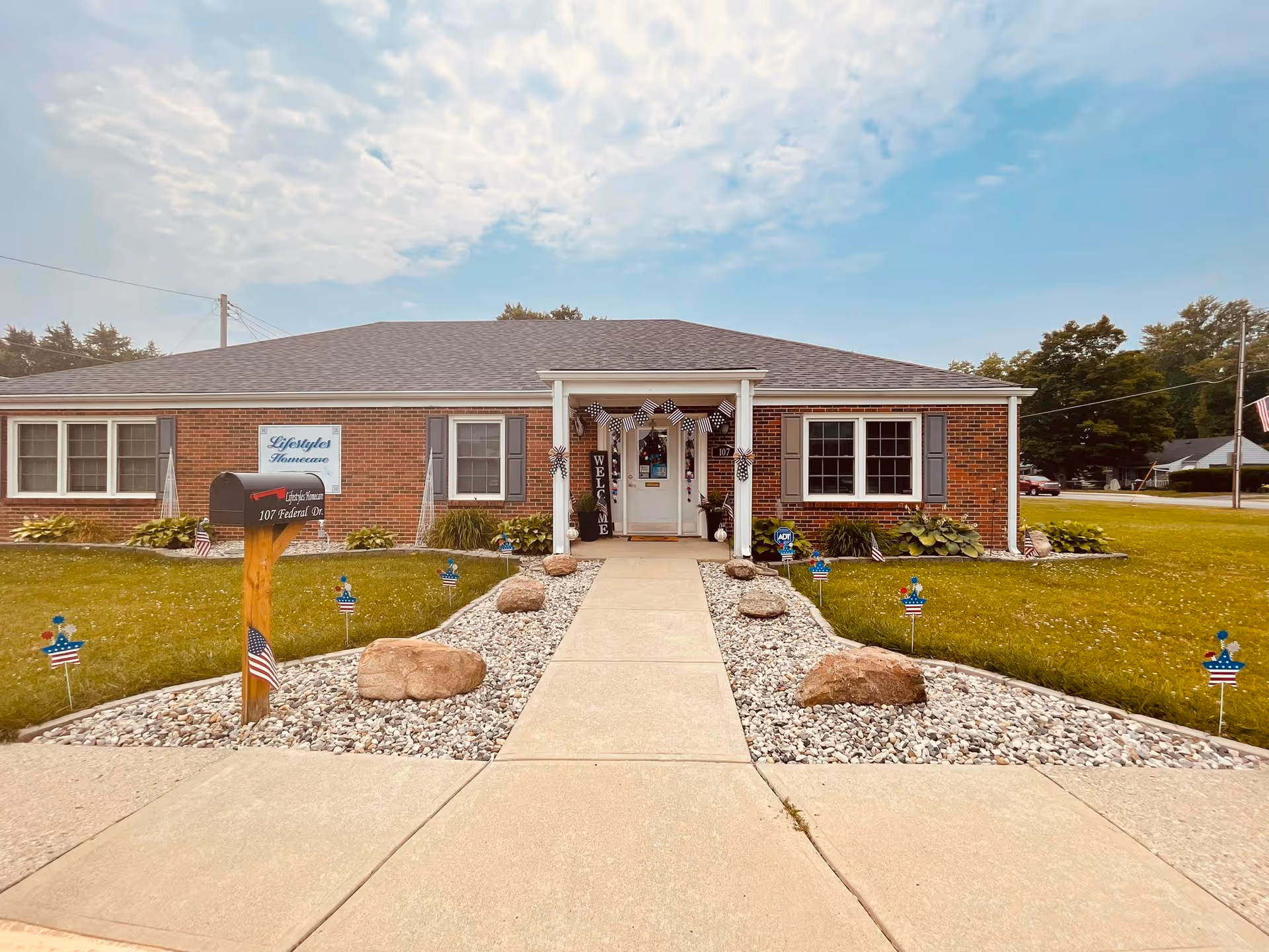 Single-story brick facility with welcoming entrance and landscaped front walkway.