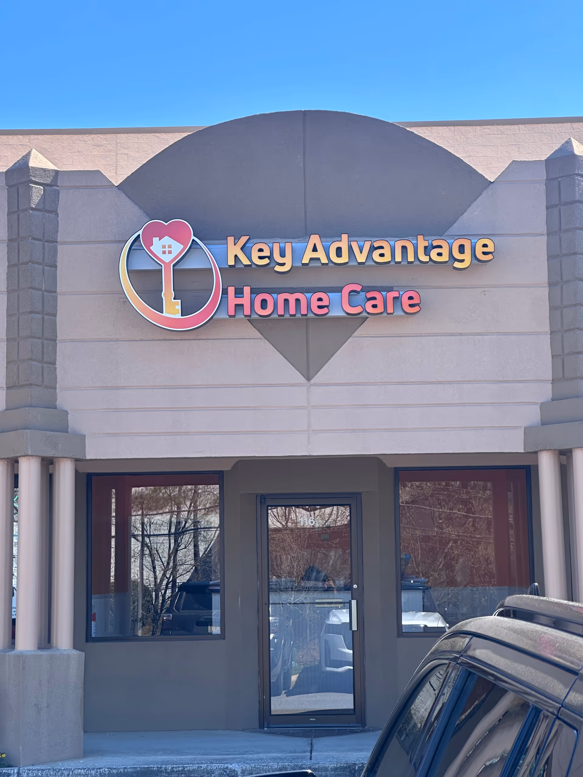 Exterior view of Key Advantage Home Care building entrance with sign.