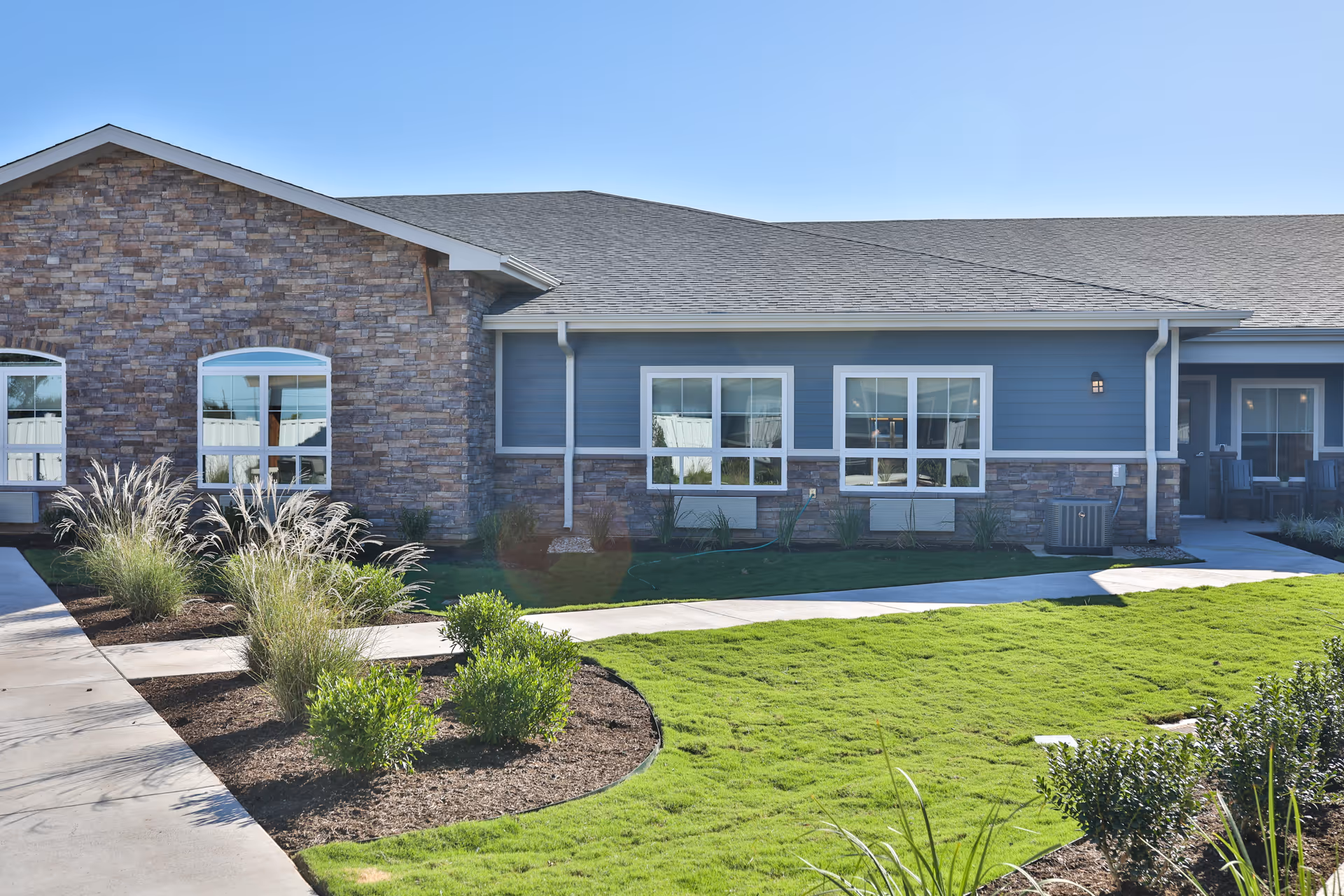 Exterior view of Towers Nursing Home with stone accents and landscaped lawn.