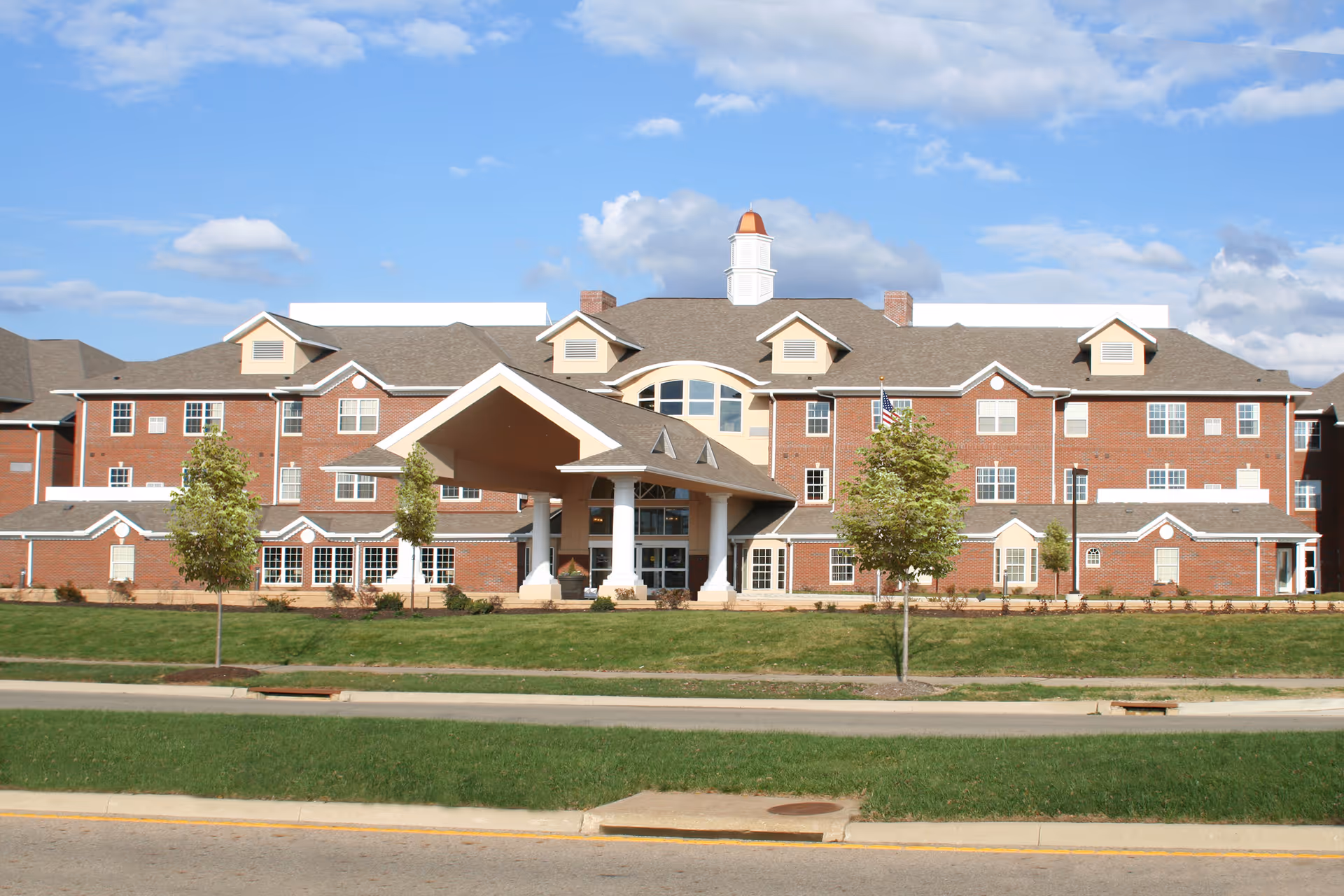 Stone Oak Retirement Community building with a covered entrance and manicured lawn.