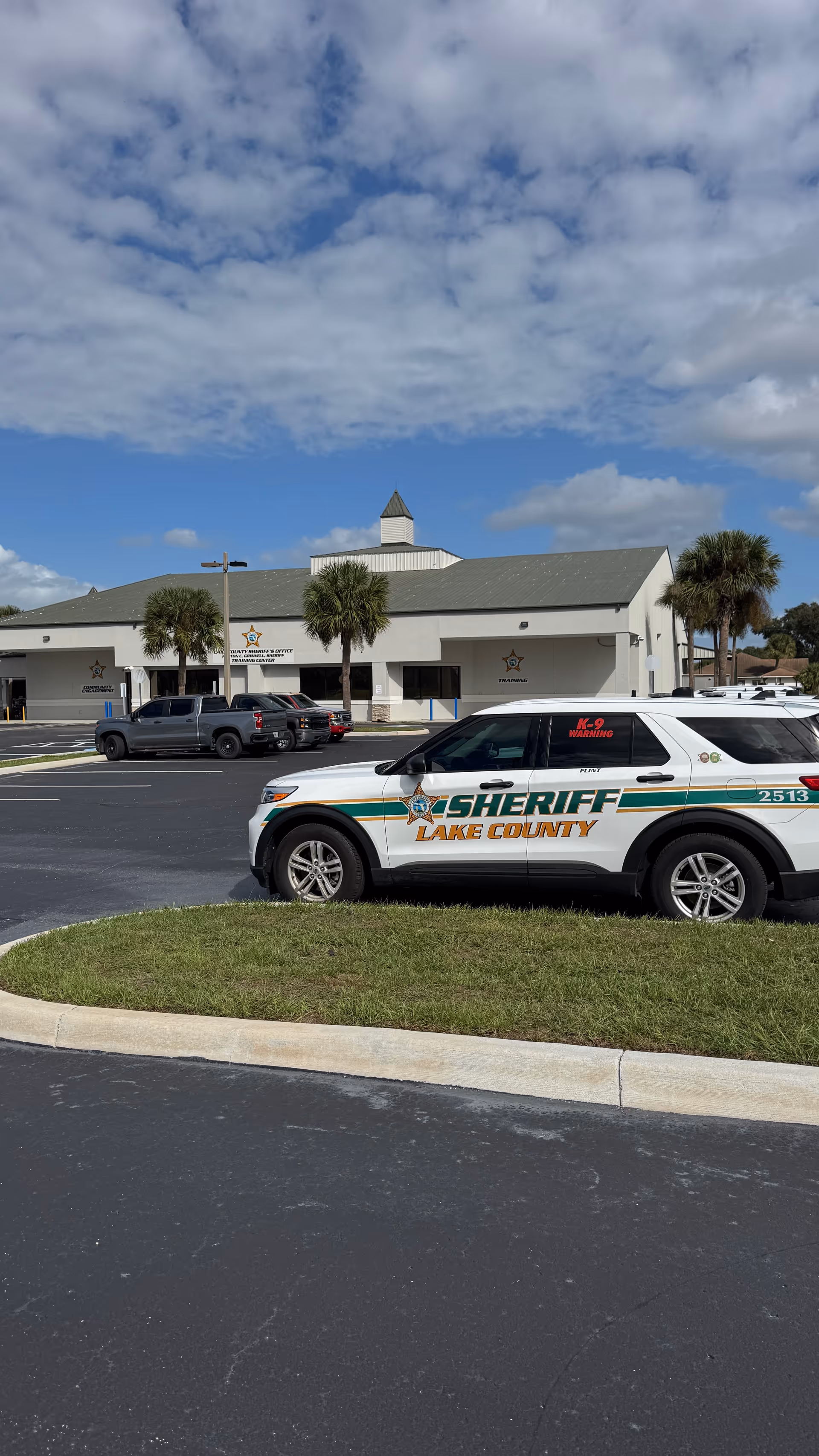 Exterior view of Cornerstone Hospice Southridge Plaza with a sheriff's vehicle in front.